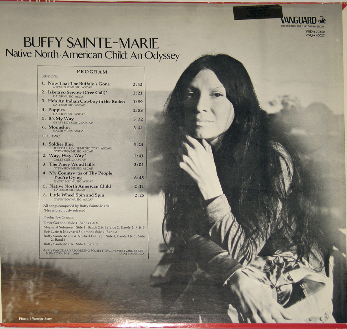 Back cover of 'Native North-American Child: An Odyssey' by Buffy Sainte-Marie. A black-and-white photograph of Buffy dominates the right side, where she gazes softly into the camera, her long, dark hair cascading over her shoulders. Her hand rests gently against her chin in a pensive yet serene pose. The left side contains the album's tracklist, printed in a clean, serif font, detailing both sides of the record. The Vanguard Records logo appears in the upper right corner, along with production credits and copyright information at the bottom.