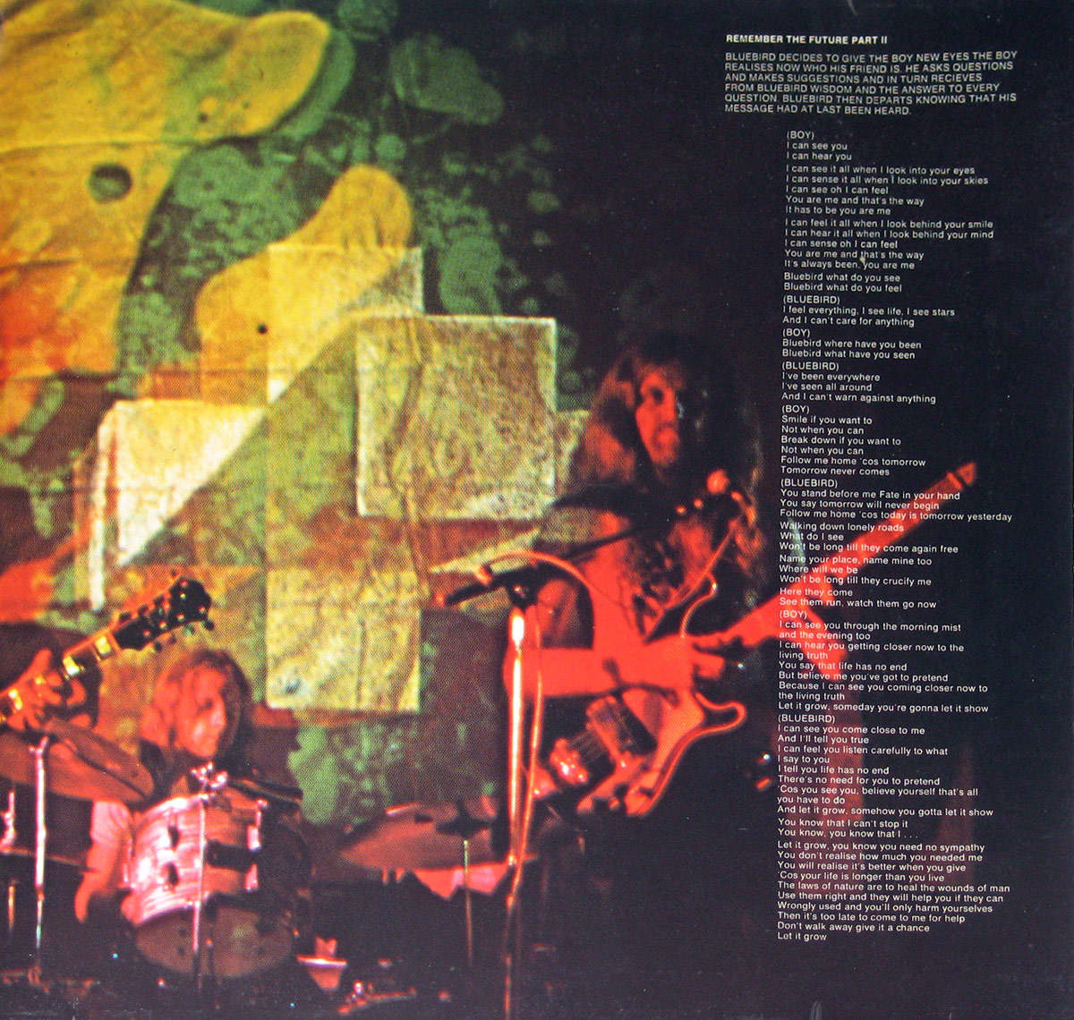 Right inside page of Nektar's 'Remember the Future' gatefold, featuring a live performance shot of the band. A bassist with long hair is seen playing under swirling psychedelic projections, while a drummer behind him is caught mid-motion. The lyrics to 'Remember the Future Part II' overlay the image in white text.