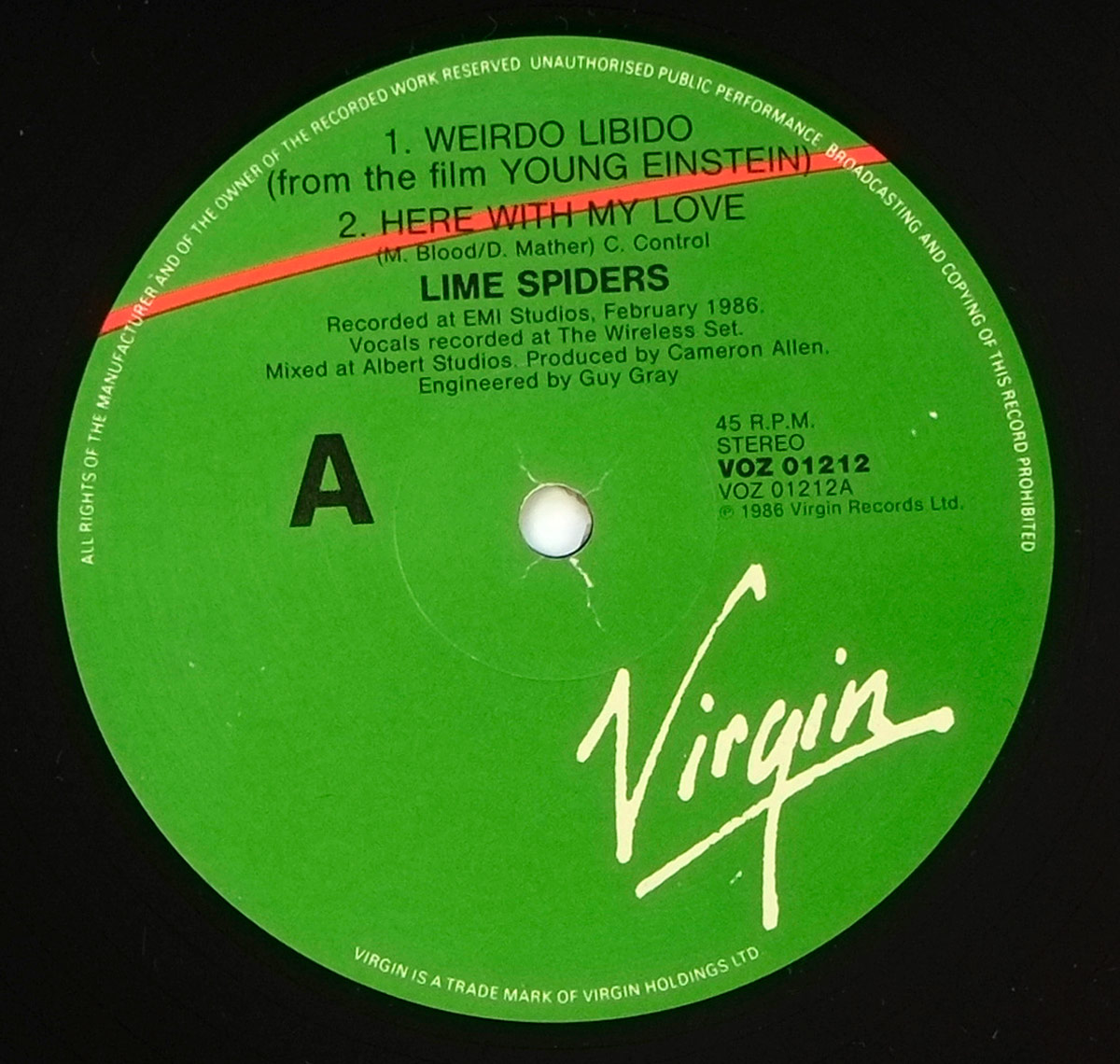 Side A label of Lime Spiders' 'Weirdo Libido' (1987) vinyl record. The label is green with black text, featuring the Virgin Records logo in white. A bold red slash crosses the top. The tracklist includes 'Weirdo Libido' and 'Here With My Love.' Recording details list EMI Studios and production credits to Cameron Allen and Guy Gray. The catalog number VOZ 01212 is printed on the right.