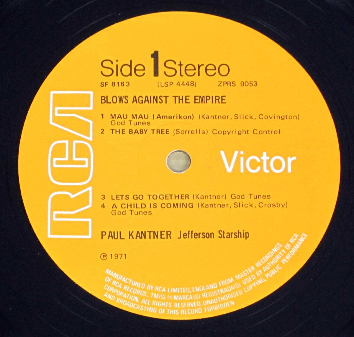 RCA record label for Side 1 of Blows Against the Empire by Paul Kantner and Jefferson Starship. The yellow label includes song titles “Mau Mau (Amerikon),” “The Baby Tree,” “Let’s Go Together,” and “A Child Is Coming,” with credits to Kantner, Slick, Covington, Sorrells, and Crosby. It displays the RCA logo, catalog number SF 8163, and manufacturing information from RCA Limited, England, dated 1971.