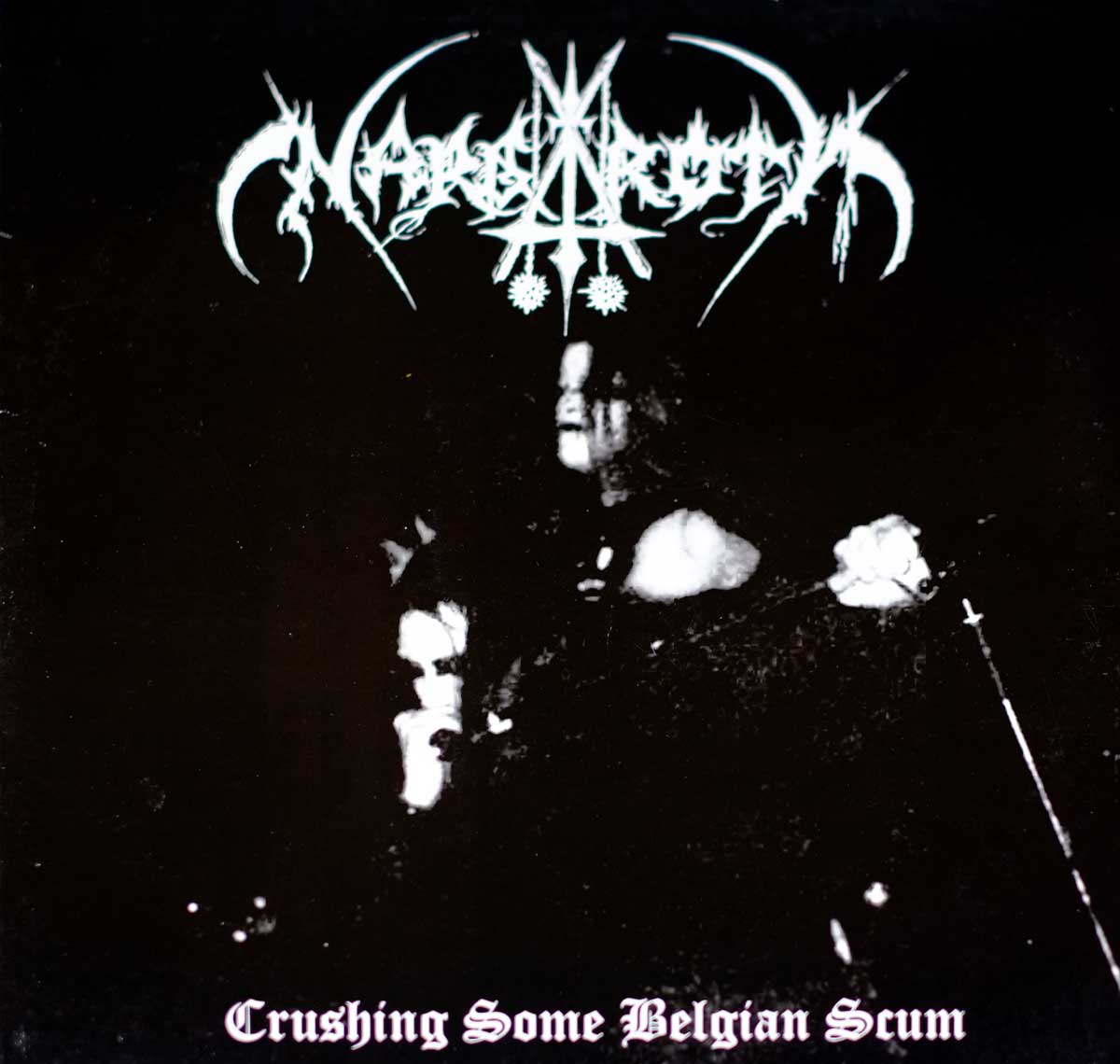 Album cover for Nargaroth’s Crushing Some Belgian Scum featuring the band’s jagged logo at the top, a shadowy fig
