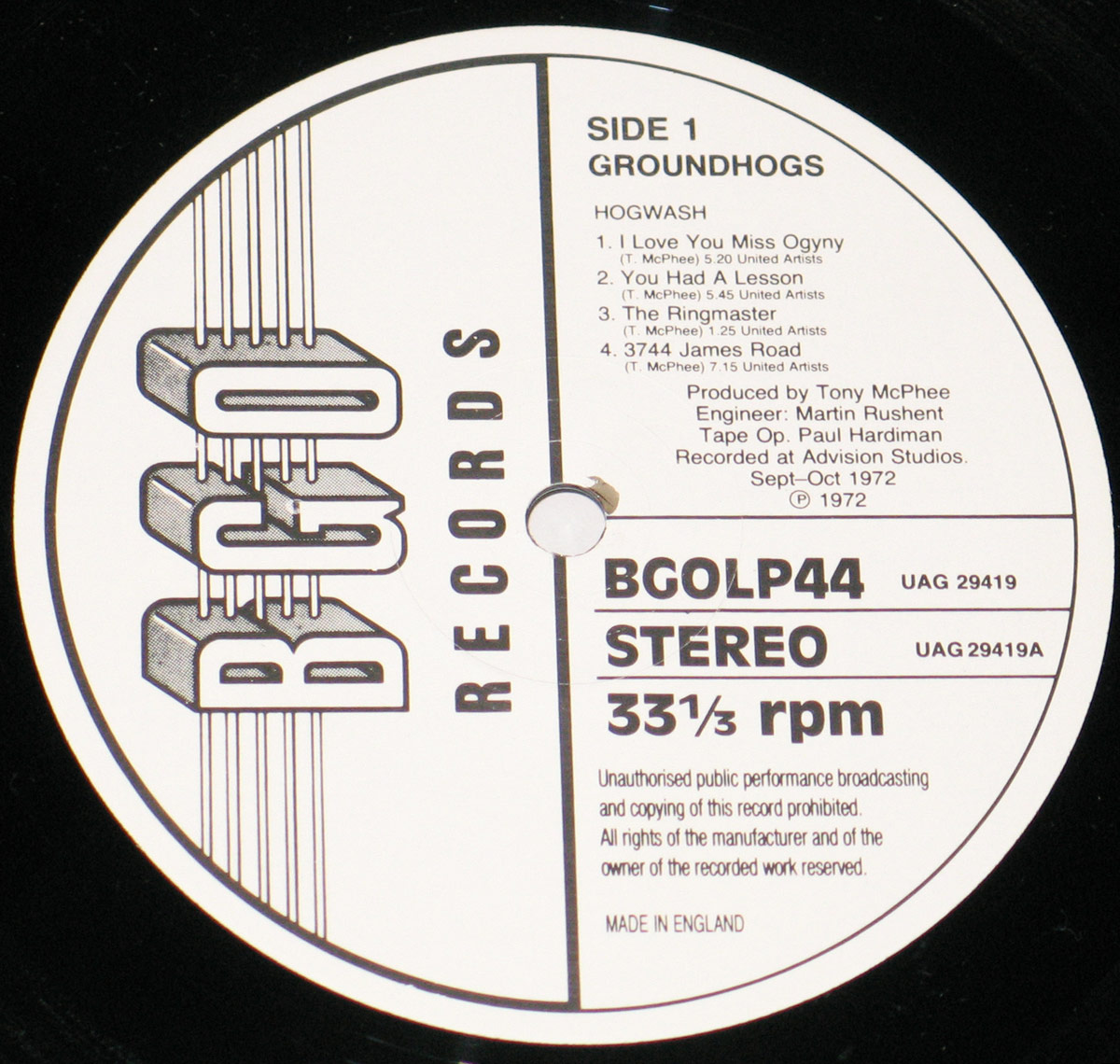 Close-up of the vinyl record label for Side 1 of 'Hogwash' by The Groundhogs, released on BGO Records. The label is black and white, featuring bold typography, tracklist, production credits, and technical details like 33 1/3 rpm speed and stereo format.