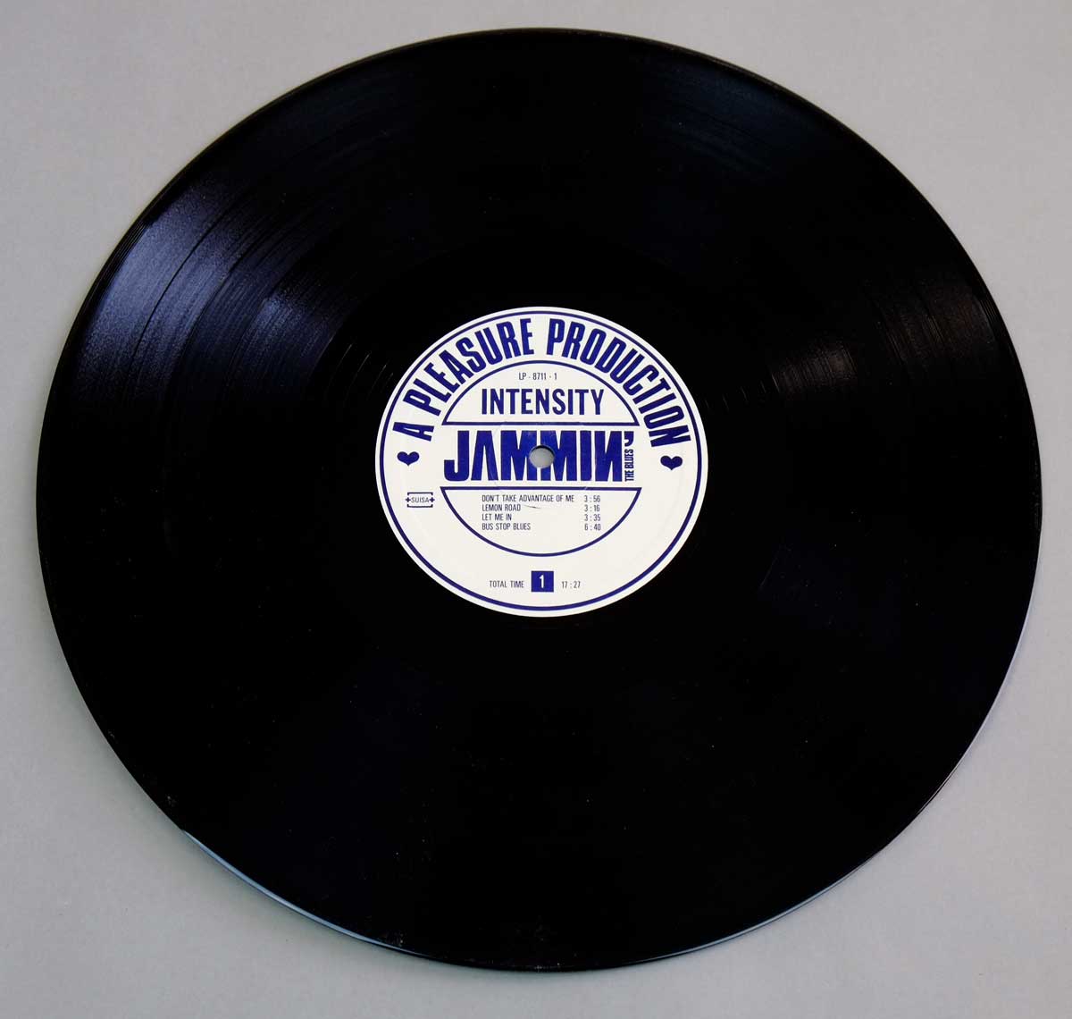 Side One of the JAMMIN' THE BLUES - Intensity LP showing a black vinyl record with white and blue center label listing four tracks and the label A Pleasure Production.