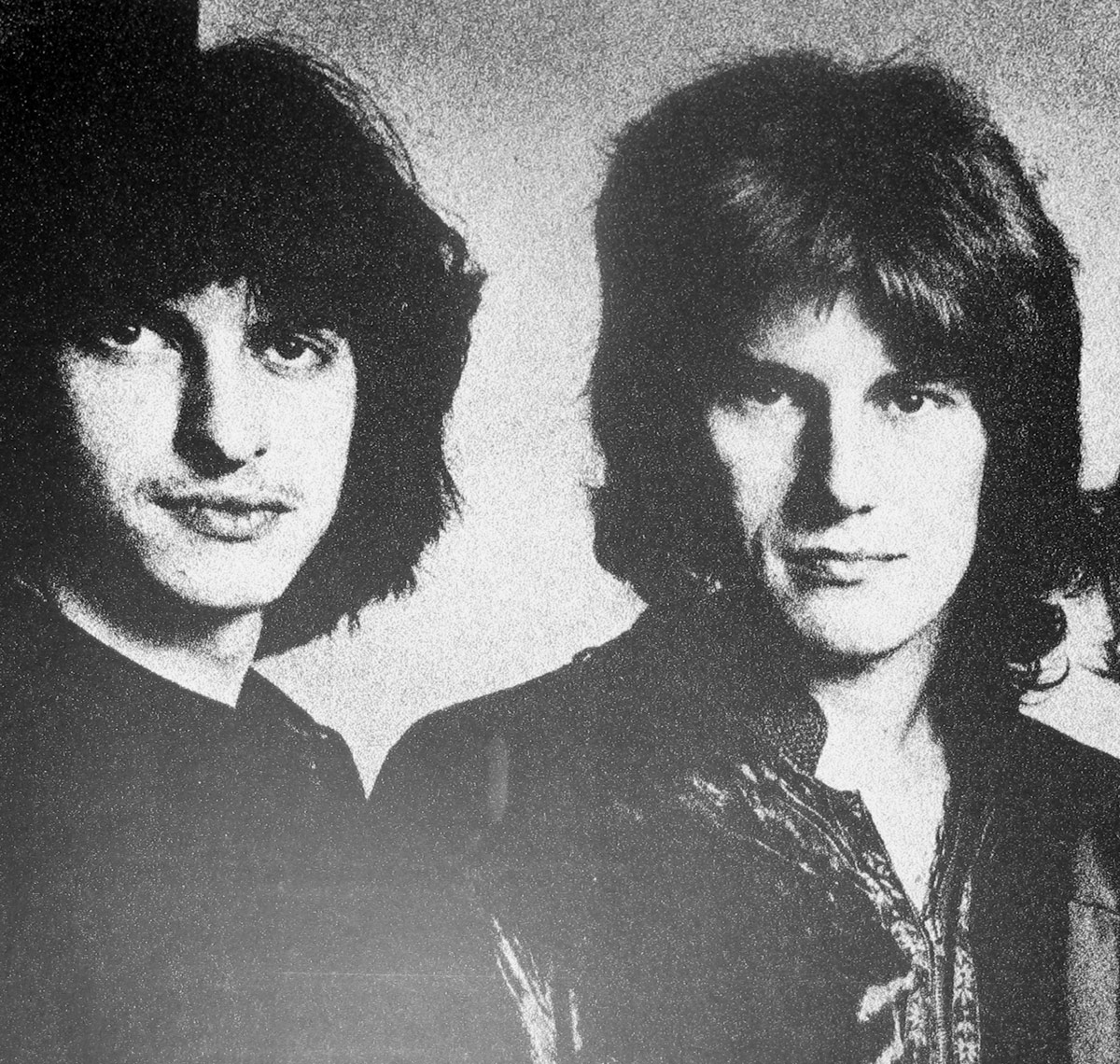 Grainy black-and-white photograph from the inside cover of 'Hear Them Calling' by Ten Years After, featuring two band members with intense expressions, long hair, and period-typical rock attire, evoking a raw, vintage aesthetic.