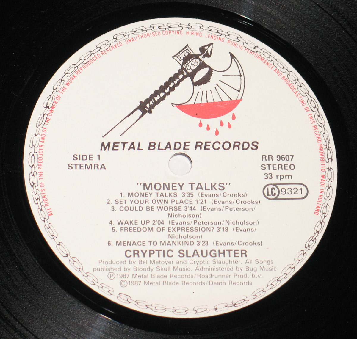 Metal Blade Records label of CRYPTIC SLAUGHTER - Money Talks Side 1. Features the iconic 'Blood Dripping Axe' logo at the top, with track listing in black text. Includes album title, band name, track durations, songwriting credits, and production details. Catalog number RR 9607, 33 RPM, and 'Made in Holland' marking on a white background with a circular black border.