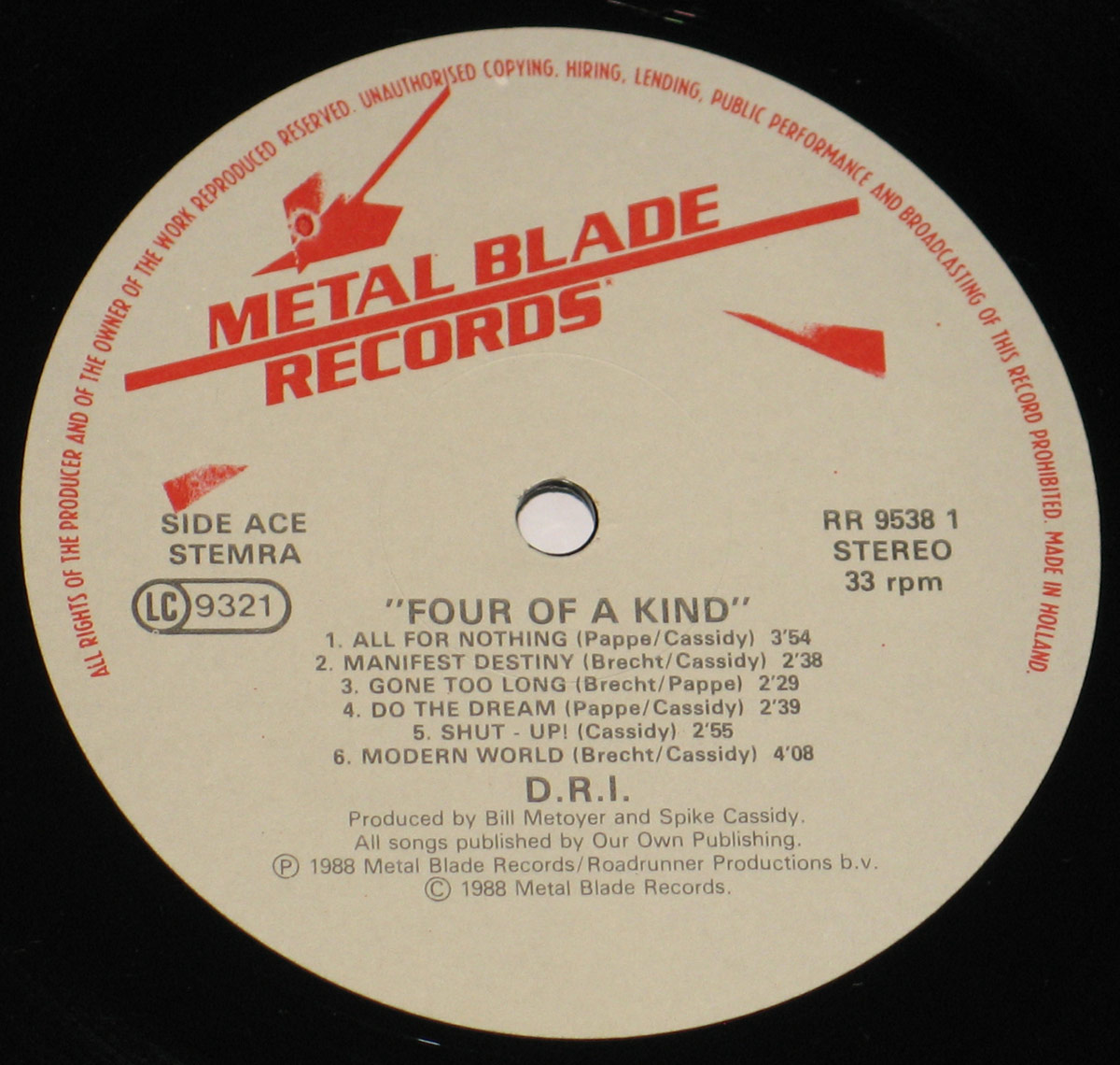 Close-up of the record label for D.R.I.'s '4 of a Kind' (1988) vinyl LP. The label features the 'Metal Blade Records' logo at the top, with a blood-dripping axe symbol. The text is printed in red and black on a cream-colored background, displaying the tracklist for 'Side Ace' with six songs and songwriting credits. The catalog number 'RR 9538 1' and '33 rpm Stereo' format are also noted. The bottom includes copyright details from Metal Blade Records and Roadrunner Productions.