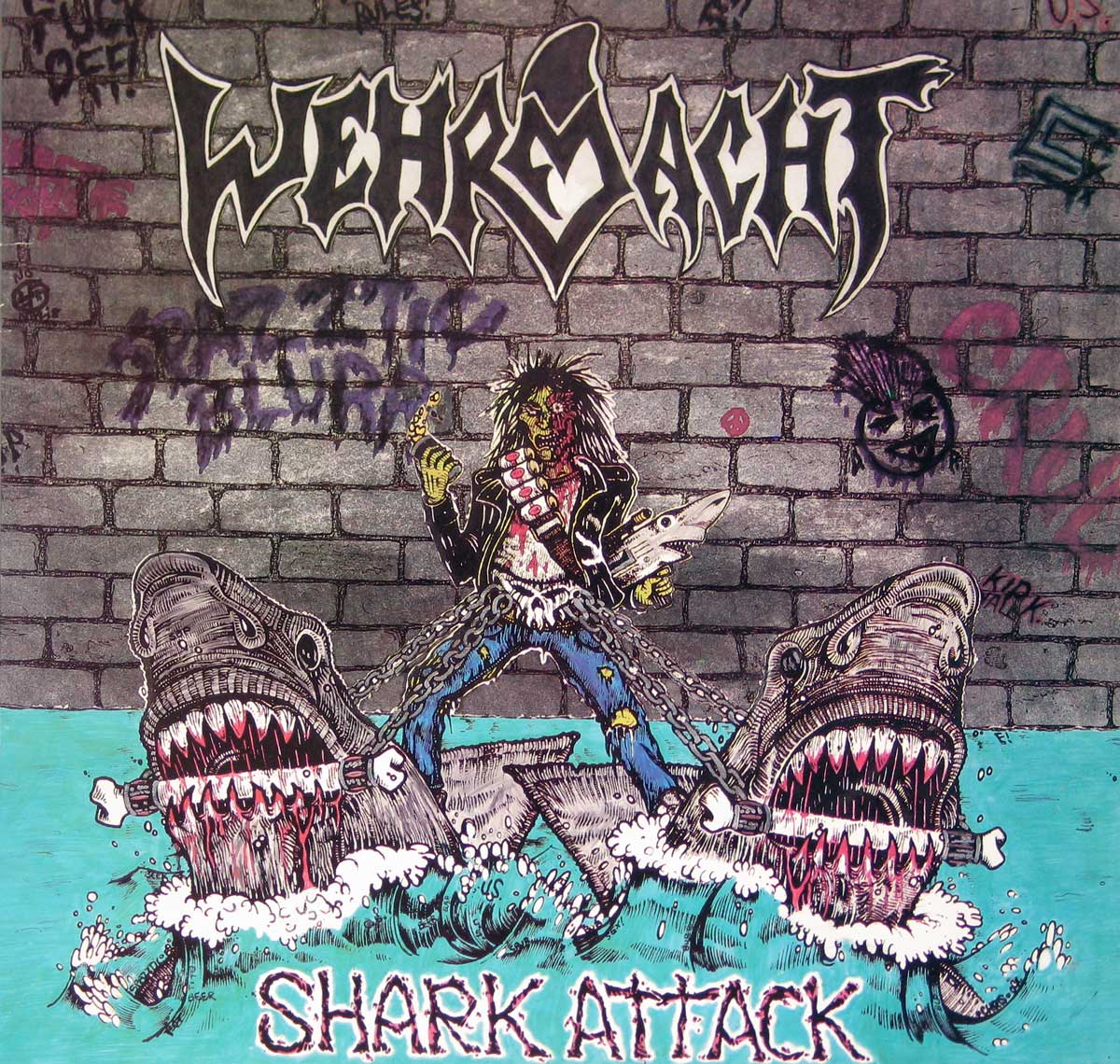 Wehrmacht Shark Attack album cover featuring a zombified rocker battling two cartoonishly vicious sharks in front of a graffiti-covered brick wall