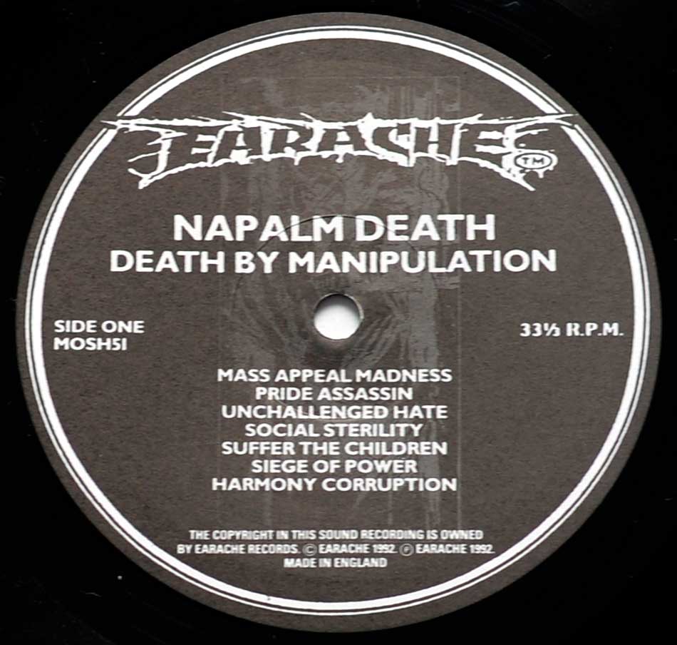 Close-up of the "Earache" Black and White Record Label for "NAPALM DEATH Death by Manipulation" 12" Side One