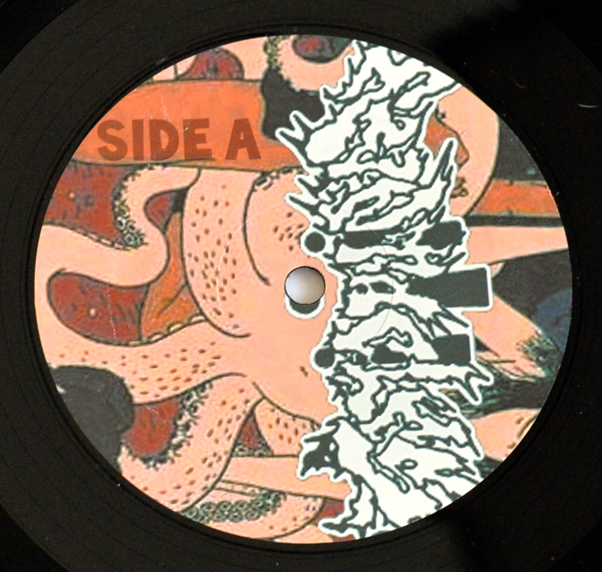 TENTACLES Self-Titled vinyl LP Side A label featuring a pink octopus, chaotic white band logo, and bold SIDE A text. Artwork blends horror and comic styles.