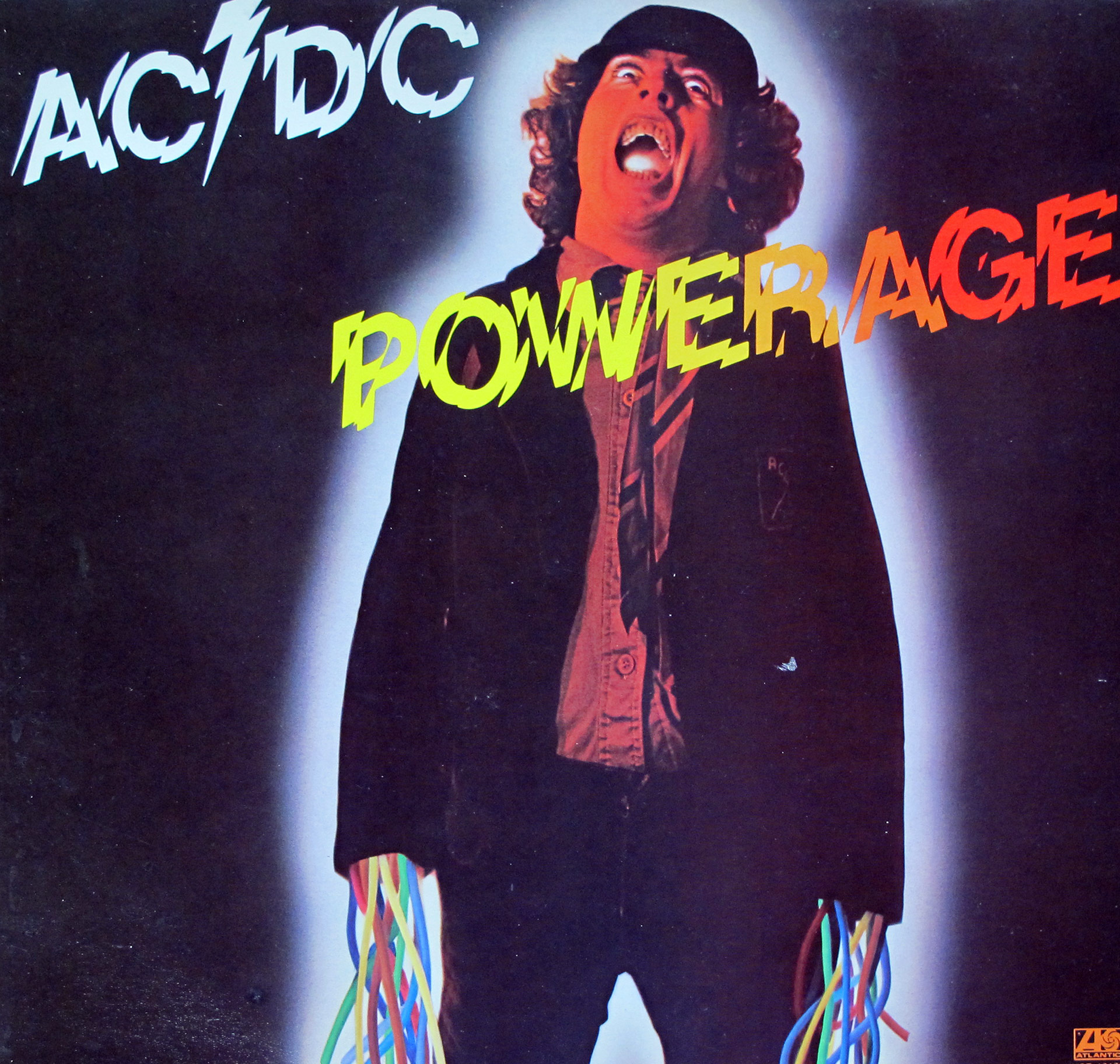 AC/DC Powerage album cover featuring a man with a shocked expression, glowing outline, and colorful electrical wires emerging from his hands, with the AC/DC logo and vibrant Powerage text on a dark background.