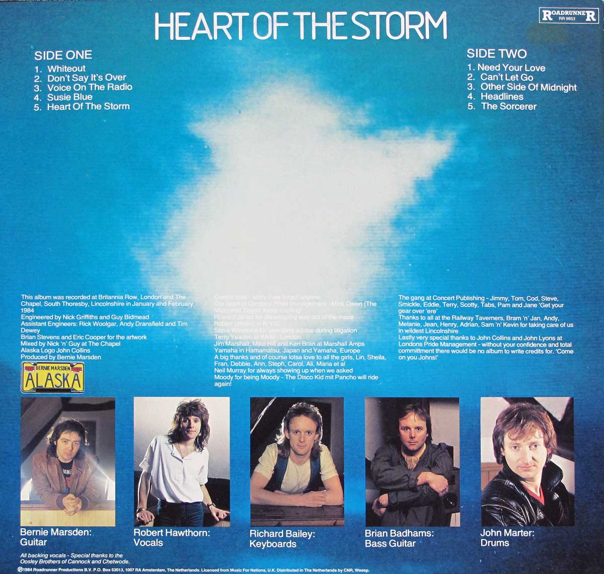 Back cover of Alaska's 1984 album Heart of the Storm featuring Bernie Marsden. It displays a centered cloudburst graphic, track listings for both sides, musician portraits, and production credits.