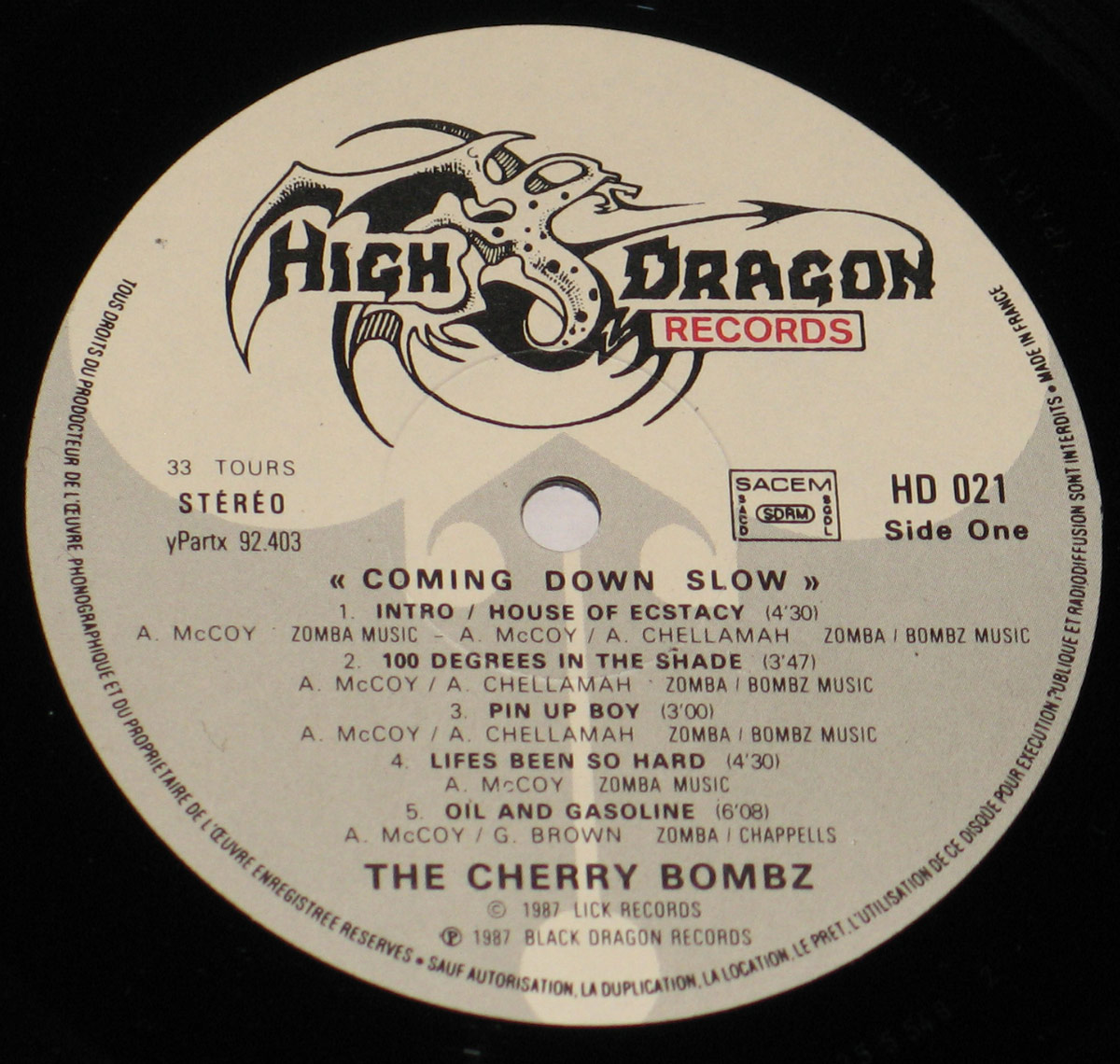 Close-up of the Cherry Bombz 'Coming Down Slow' vinyl record label, Side One, issued by High Dragon Records, catalog number HD 021, listing five tracks with credits and durations.