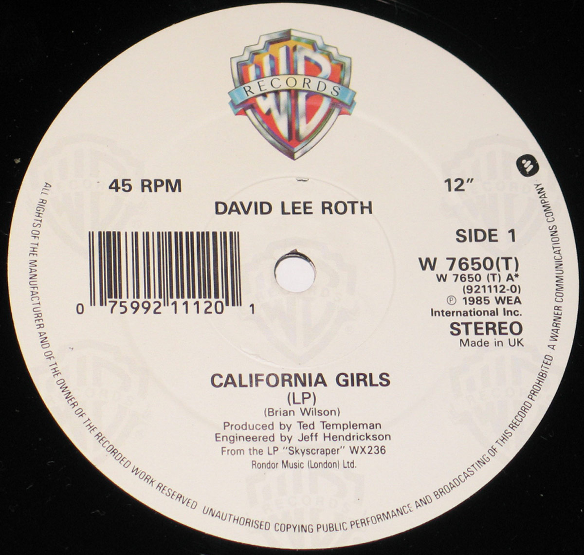 Close-up of Side 1 record label from the UK release of David Lee Roth's California Girls maxi-single, showing Warner Bros Records logo, catalog number W 7650(T), and production credits.