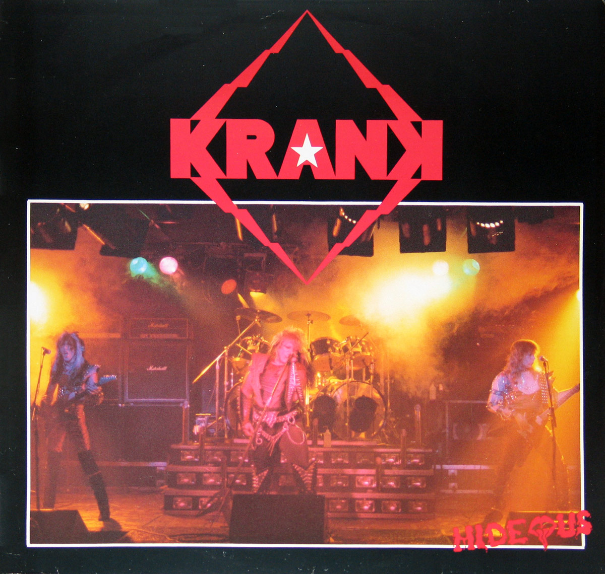 Front cover of Krank's 1986 album Hideous. The cover features a live concert photo of the band on stage with dramatic yellow and red lighting. The lead singer in the center, dressed in studded leather, plays guitar and sings into a microphone. To the left and right, two guitarists in flashy metal attire are also performing. Behind them, a drummer is visible, partially obscured by his drum kit. The stage is lit by colorful spotlights and Marshall amplifiers are stacked in the background. The band's name, Krank, appears at the top in bold red letters within a geometric diamond shape, and the album title Hideous is in red at the bottom right, stylized with a jagged font. https://vinyl-records.nl/