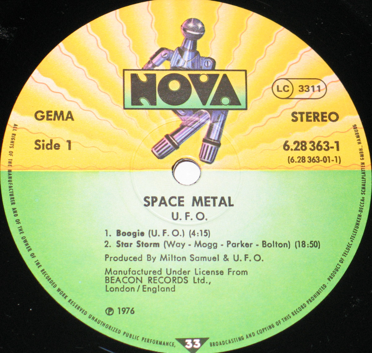 Close-up of Side One record label for UFO's 'Space Metal' 12-inch vinyl double LP. The circular label is split into two sections: a bright yellow top half with a mechanical robot illustration behind the 'NOVA' logo, and a green bottom half containing track information, production credits, and licensing details.