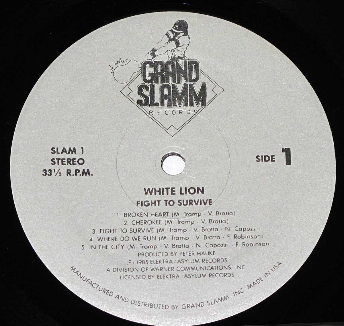 Record label of White Lion’s Fight to Survive album, featuring the Grand Slamm Records logo with a hockey player and flame design, the album’s title and tracklist for Side 1, and production and manufacturing details in a clean, grey minimalist layout.