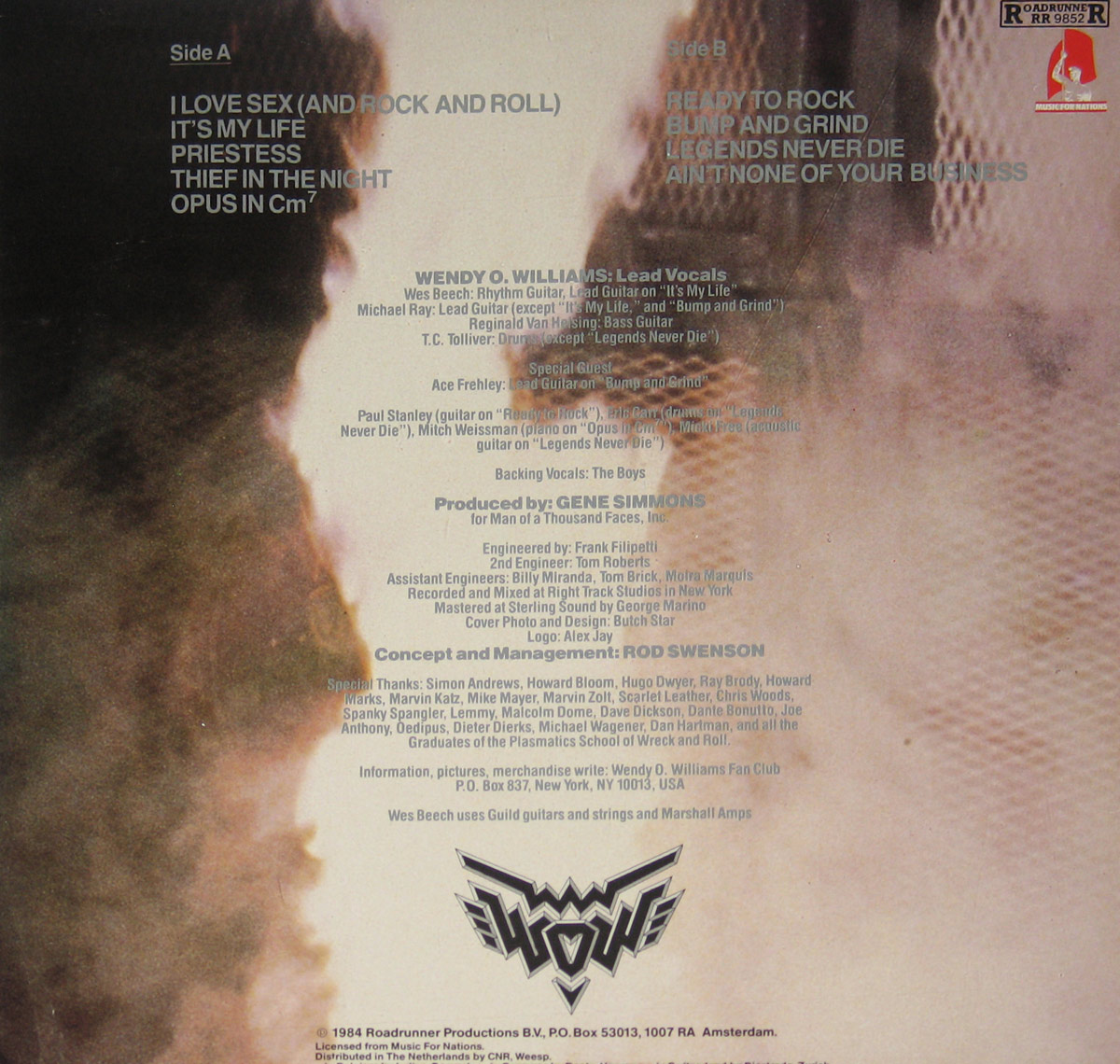 Back cover of Wendy O. Williams – WOW vinyl LP. The image shows a vertically split background with dark smoke or shadow on the left and a metallic mesh texture on the right. Track listings for Side A and Side B appear at the top corners. Centered text lists musicians, production credits, engineering details, and acknowledgements. The WOW logo is printed near the bottom, with Roadrunner Records copyright and distribution information along the lower edge.