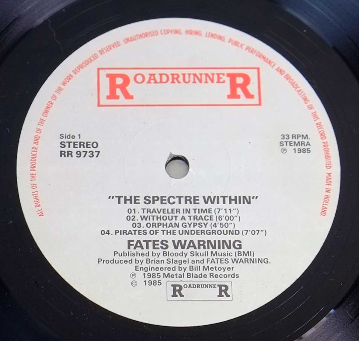 Close-up of Side One label on 'Fates Warning - The Spectre Within' vinyl, featuring track listing, Roadrunner Records logo, and production details. https://vinyl-records.nl