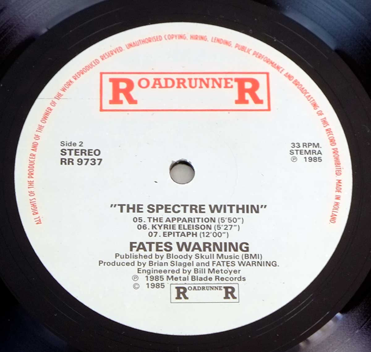 Close-up of Side Two label on 'Fates Warning - The Spectre Within' vinyl, displaying track listing, Roadrunner Records logo, and production credits. https://vinyl-records.nl