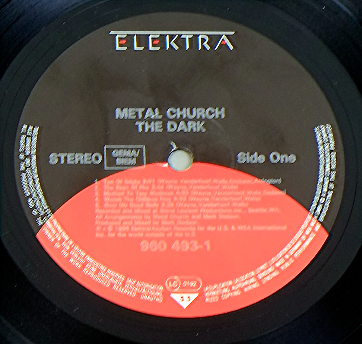 Vinyl record label for Metal Church’s album The Dark, featuring a two-tone brown and red design, Elektra Records logo, album title, band name, catalog number 960 493-1, and production details