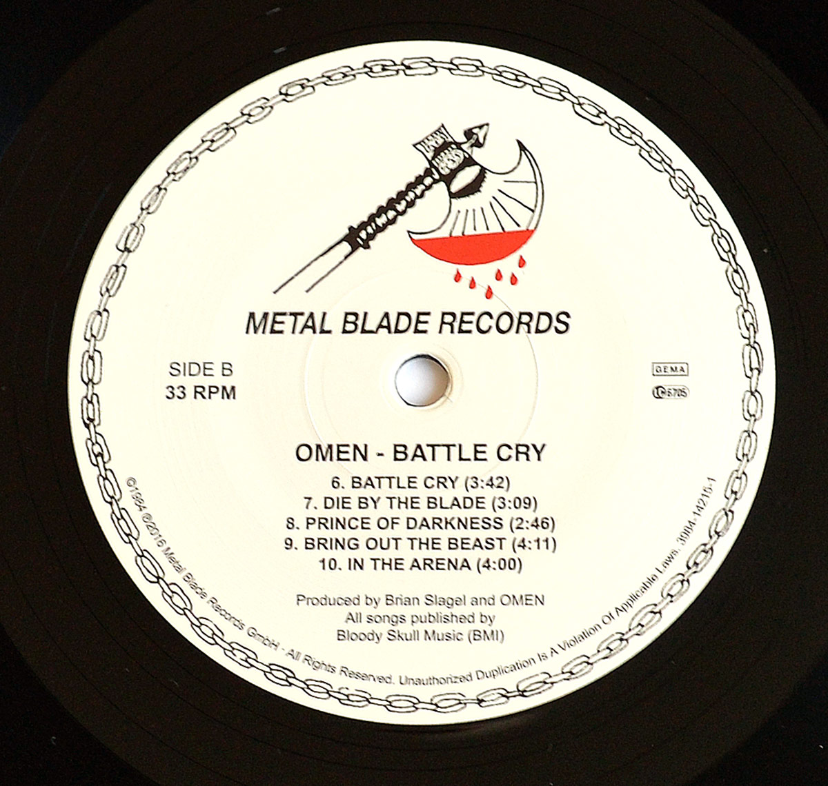 OMEN - Battle Cry Side Two record label: Features Metal Blade Records’ blood-dripping axe logo, tracklist including 'Battle Cry' and 'Die By The Blade,' and production credits. Visit https://vinyl-records.nl