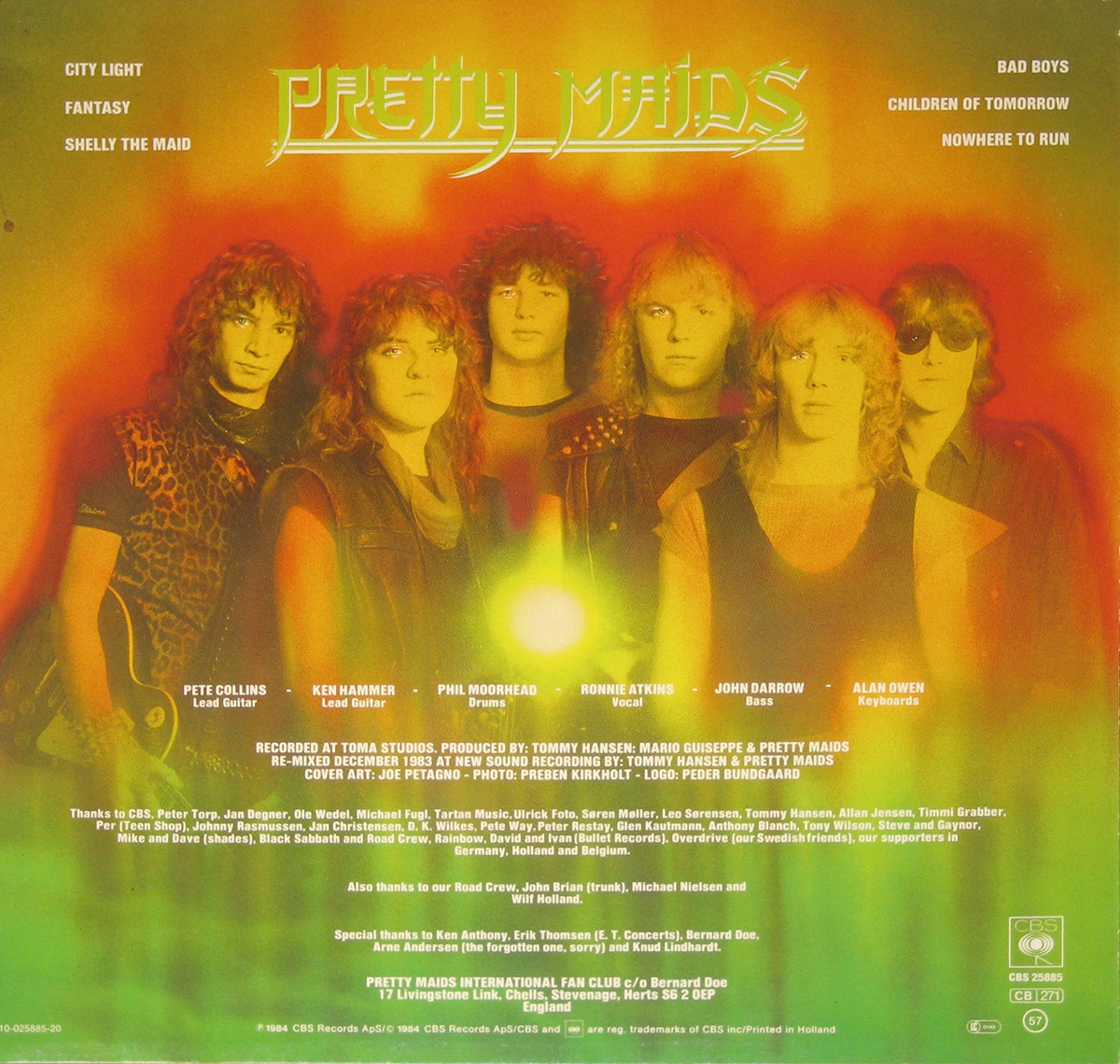 Back cover of Pretty Maids’ self-titled album featuring a group portrait of the band members: Pete Collins (lead guitar), Ken Hammer (lead guitar), Phil Moorhead (drums), Ronnie Atkins (vocal), John Darrow (bass), and Alan Owen (keyboards), set against a fiery orange and red background with track titles and credits displayed.