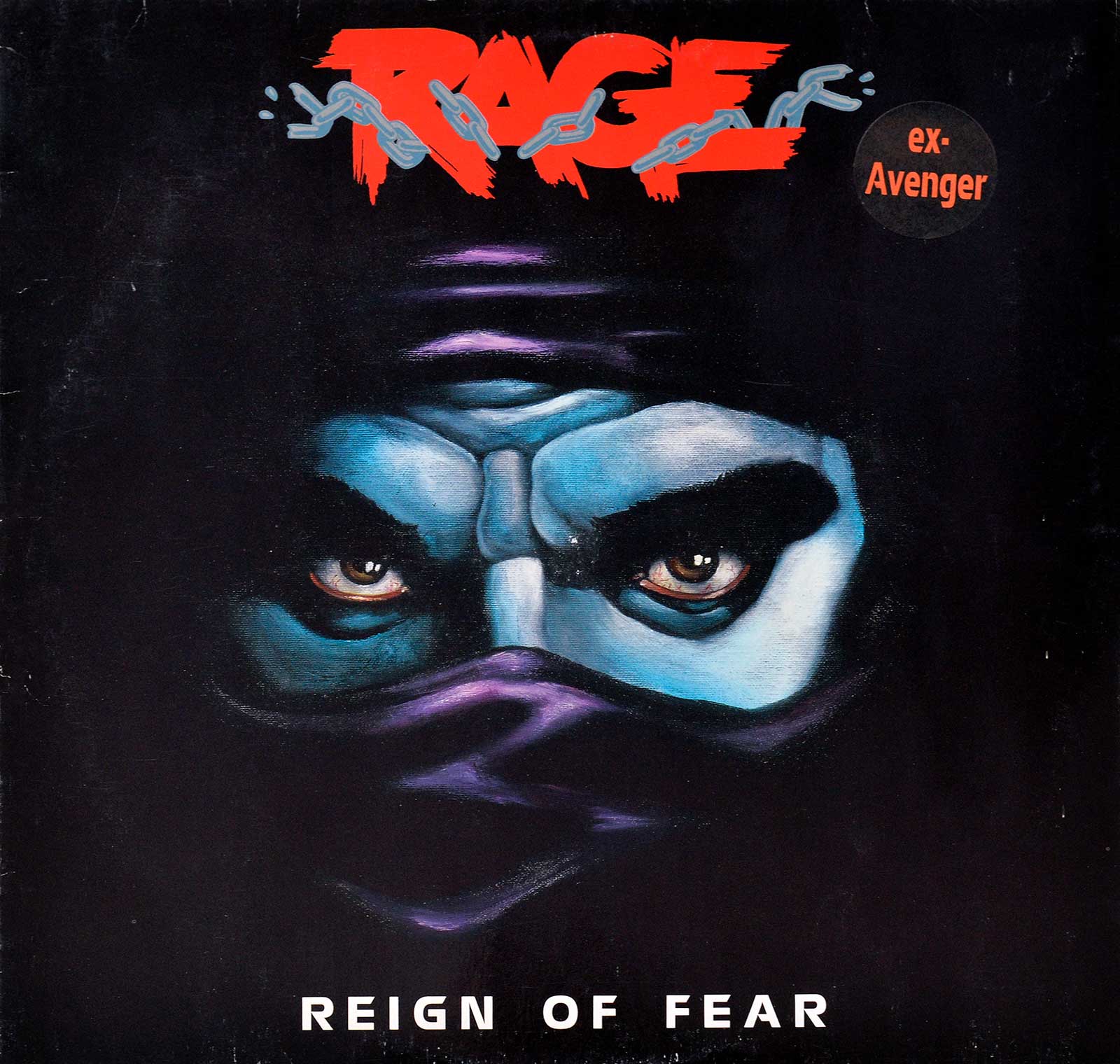 lbum cover of Rage's 'Reign of Fear' featuring a close-up of a masked face with intense eyes, painted in blue-grey tones against a dark background. The band's name 'RAGE' appears in bold red lettering with a chain graphic, and a small sticker in the corner reads 'ex-Avenger.' The album title 'Reign of Fear' is printed in white at the bottom.