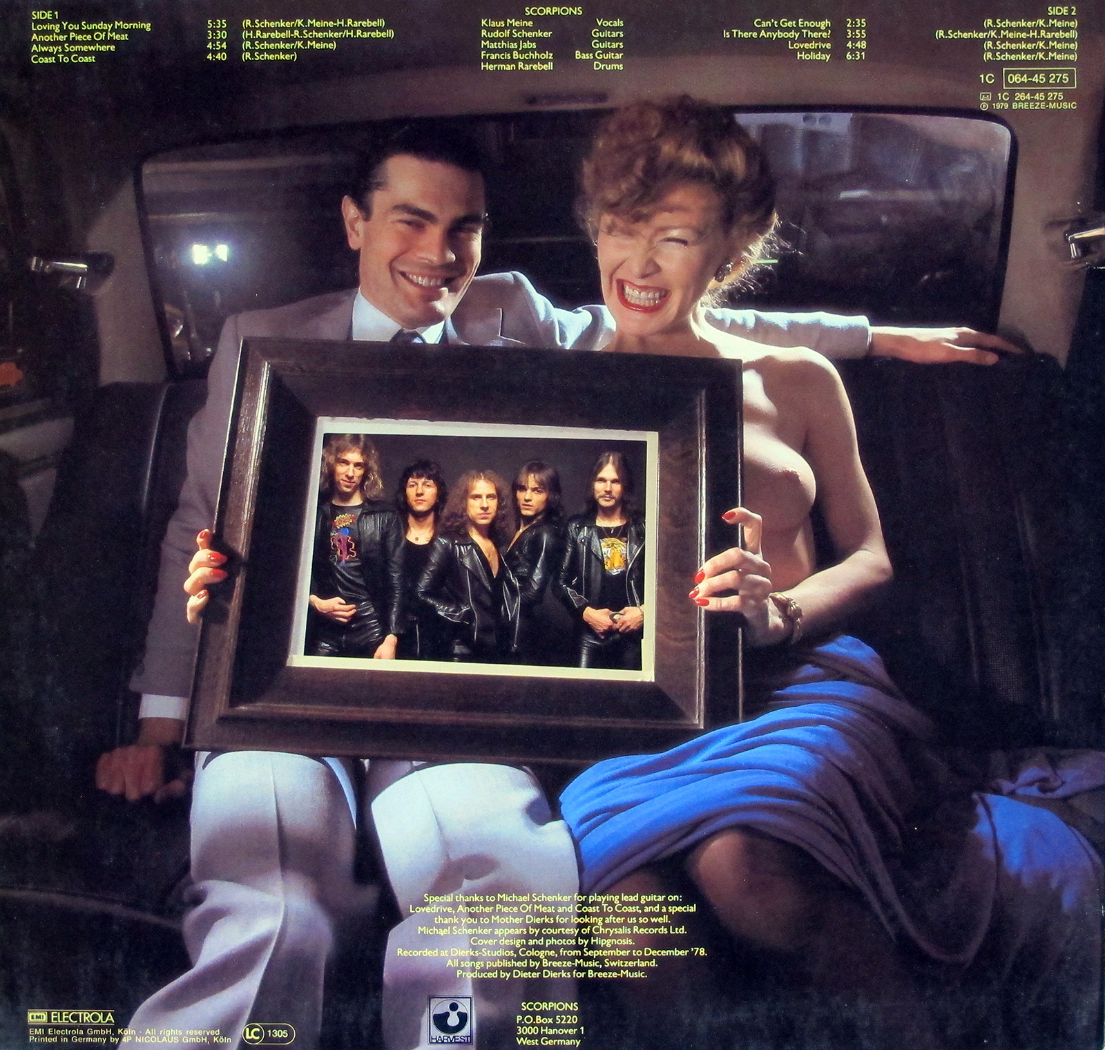 Back cover of Scorpions' Lovedrive German release showing a man in a light blue suit and a woman in a blue dress seated in a car, holding a framed photo of the band members dressed in black leather jackets. Album credits and production details are printed on the upper and lower sections.