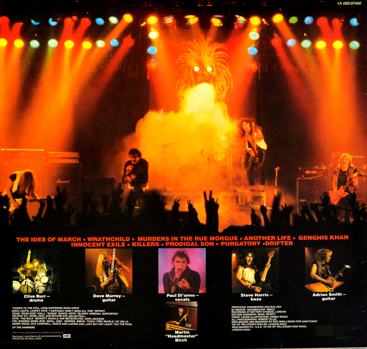 Back cover of Iron Maiden's 'Killers' Netherlands 12-inch LP featuring a dramatic live concert photo under blazing stage lights, with Paul Di’Anno singing at center, Dave Murray and Adrian Smith on guitars, Steve Harris on bass, and the glowing Eddie backdrop looming behind smoke. The crowd appears in silhouette, and the lower section shows musician portraits, track titles, production credits, the catalog number 1A 062-07450, and Dutch-specific identifiers including PRINTED IN HOLLAND and EMI marketing/manufacturing information unique to this edition.