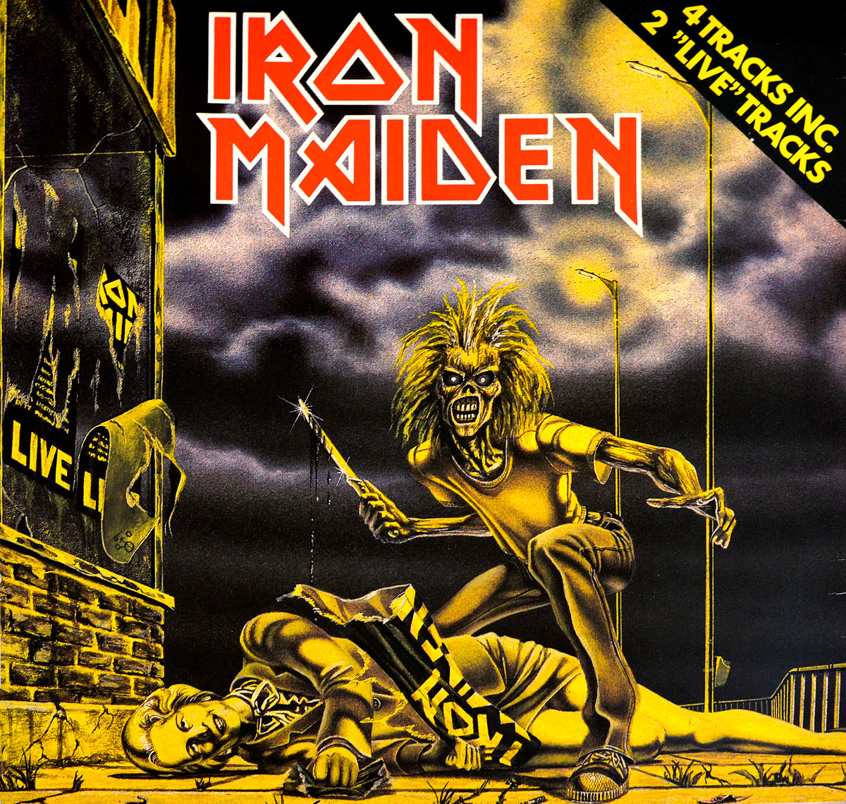 Iron Maiden Sanctuary EP Netherlands front cover with Eddie crouching over Margaret Thatcher on pavement, knife in right hand, torn political poster across her body, yellow-black color scheme, brick wall and posters on left, streetlights and cloudy sky in background, slight print softness and warmer tones visible across sleeve