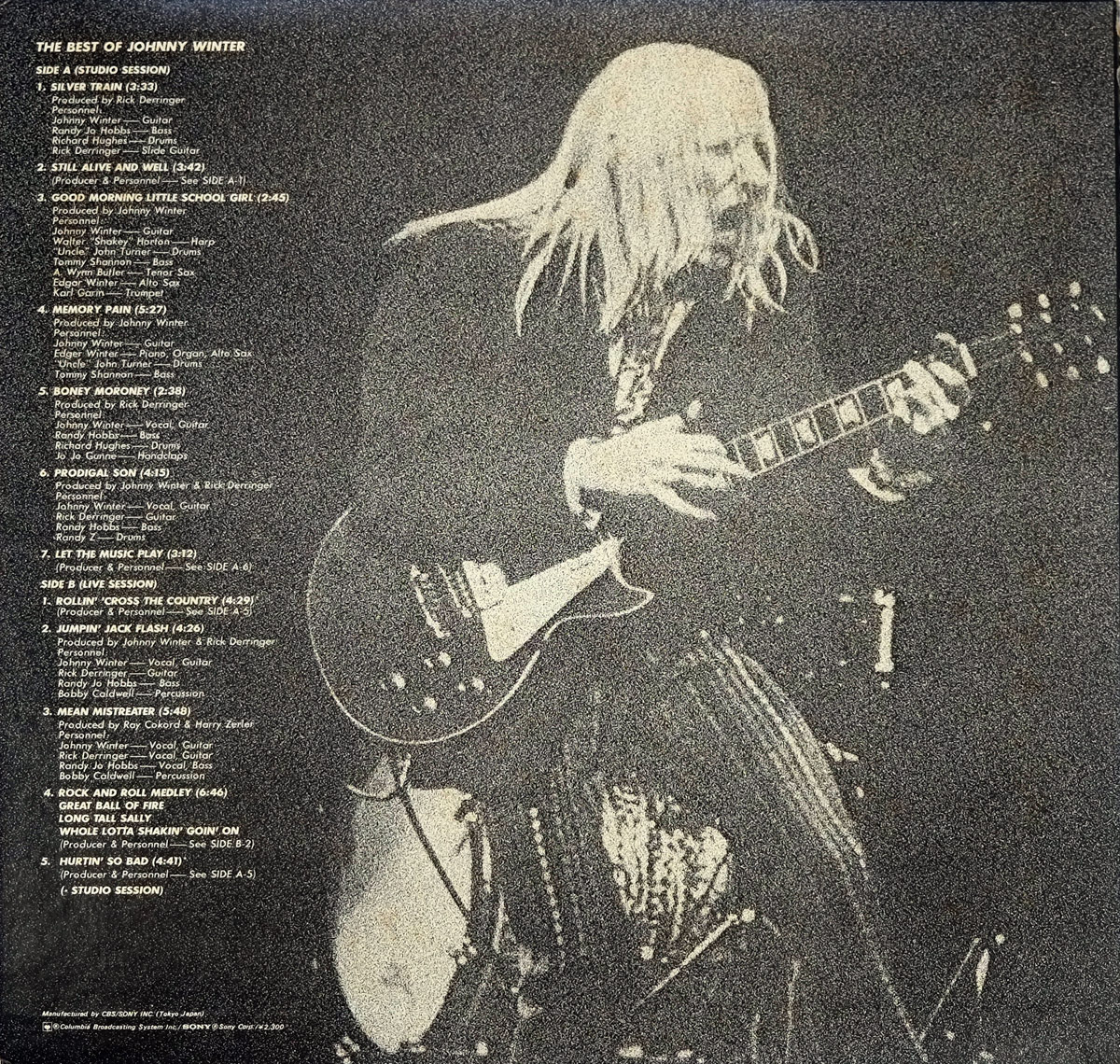 Sepia-toned image of Johnny Winter playing a Gibson Les Paul on stage, featured on the back cover of 'The Best of Johnny Winter' Japanese LP. The full tracklist is printed on the left.