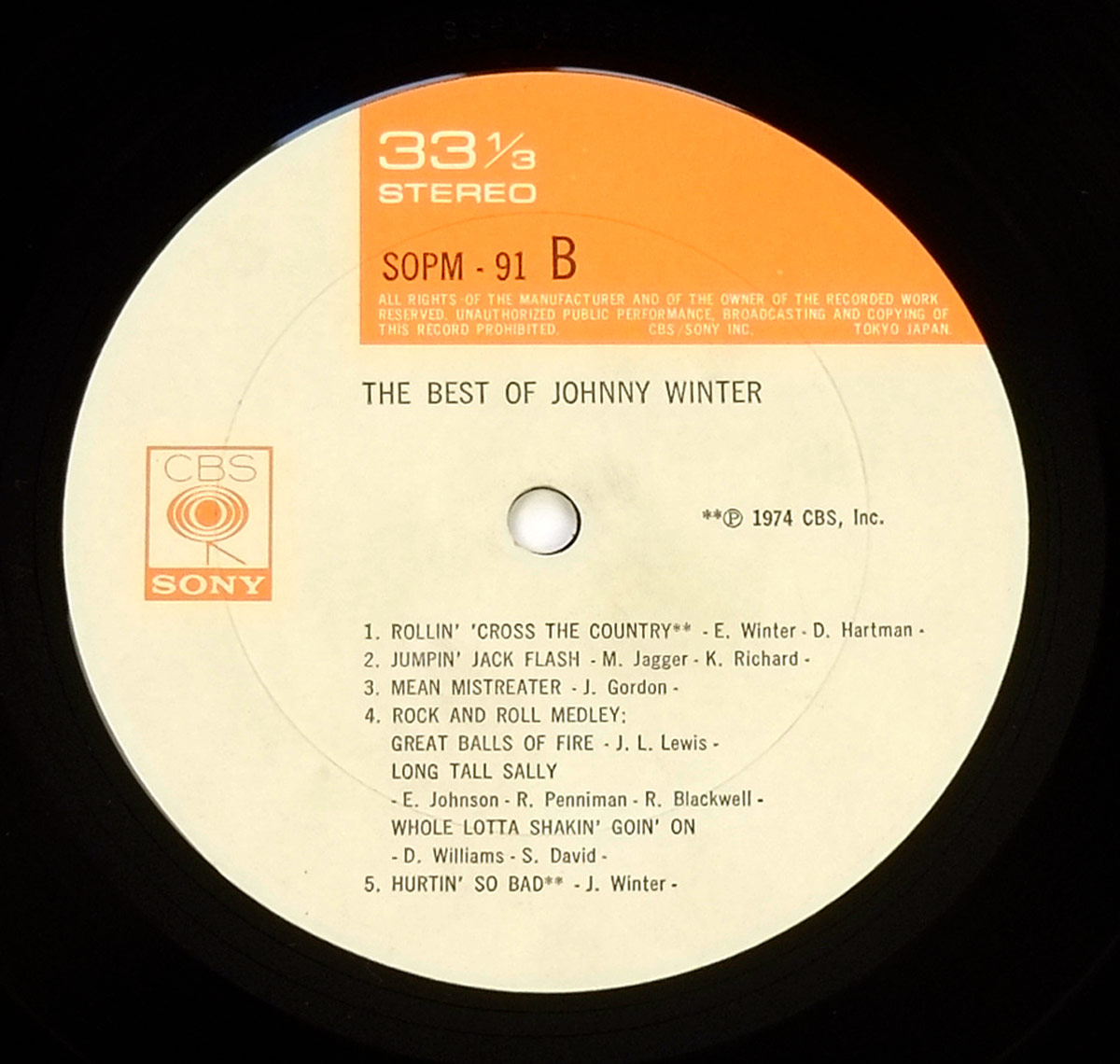 Side Two label of 'The Best of Johnny Winter' Japanese LP release, featuring CBS Sony logo, catalog number SOPM 91 B, and track titles with songwriting credits and 1974 copyright.