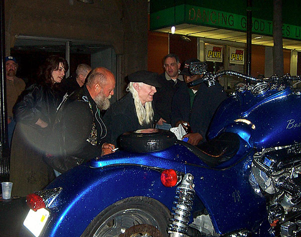 Photo of Johnny Winter Signs 2003 Boss Hoss Monster Bike 