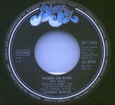 Blue Sky record label for Johnny Winter’s single Raised on Rock, catalogue number SKY S 3092, made in Germany with production credits to Shelly Yakus, released in 1975 under John Dawson Winter III album.
