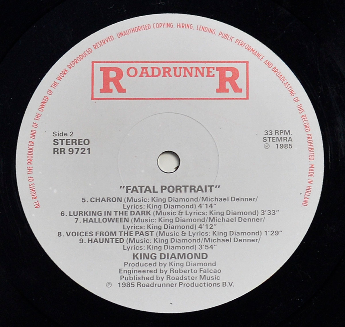 KING DIAMOND - Fatal Portrait Netherlands RoadrunneR RR 9721 record label close-up, Side 2 STEREO, 33 RPM, STEMRA, ℗ 1985, boxed red RoadrunneR logo, side two track list including Charon, Halloween, Voices From The Past, Haunted, red rim text ending MADE IN HOLLAND, visible spindle wear.
