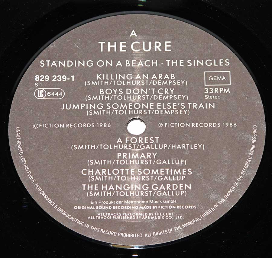 Close up of Side One record's label "Standing On a Beach" Record Label Details: Fiction Records 829 239 © 1986 Fiction Records Copyright ℗ 1986 Fiction Records Sound Copyright 