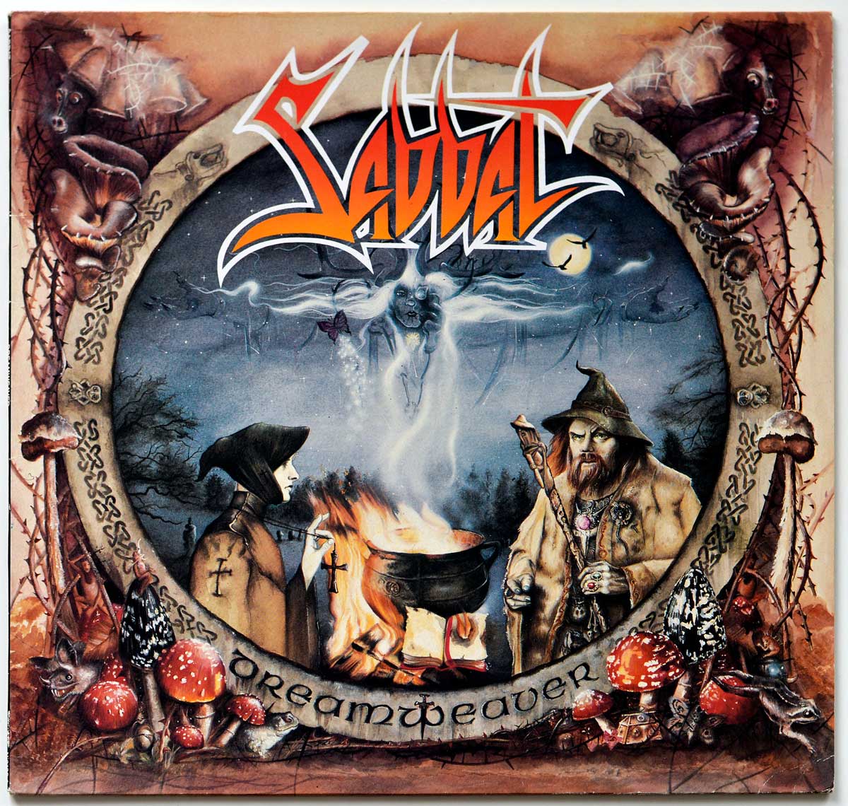 Album cover of Sabbat’s Dreamweaver featuring a mystical scene with a hooded figure and a bearded shaman gathered around a fire. Ethereal spirits rise above the flames into a dark, moonlit sky, surrounded by a circular frame with runes and Celtic designs. The border is adorned with mushrooms and other natural elements, capturing the album’s pagan and occult theme. The band’s logo is displayed prominently at the top, with the album title “Dreamweaver” written in medieval-style script at the bottom.