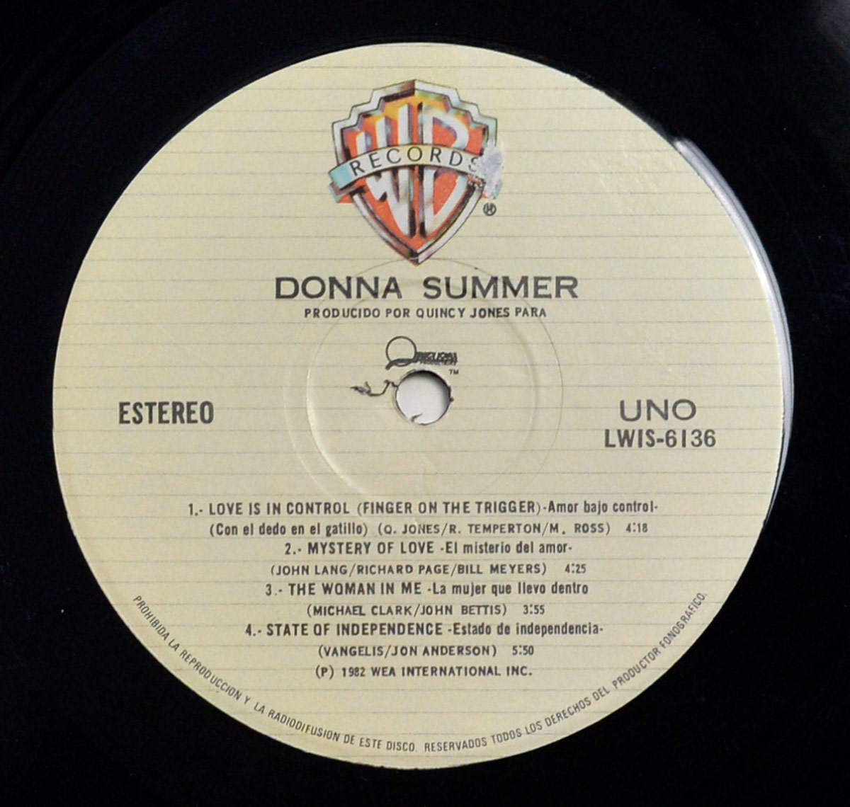 Side One of Donna Summer's self-titled album shows a beige Warner Bros. label with tracklist in English and Spanish, catalog number LWIS-6136, stereo, and production by Quincy Jones.