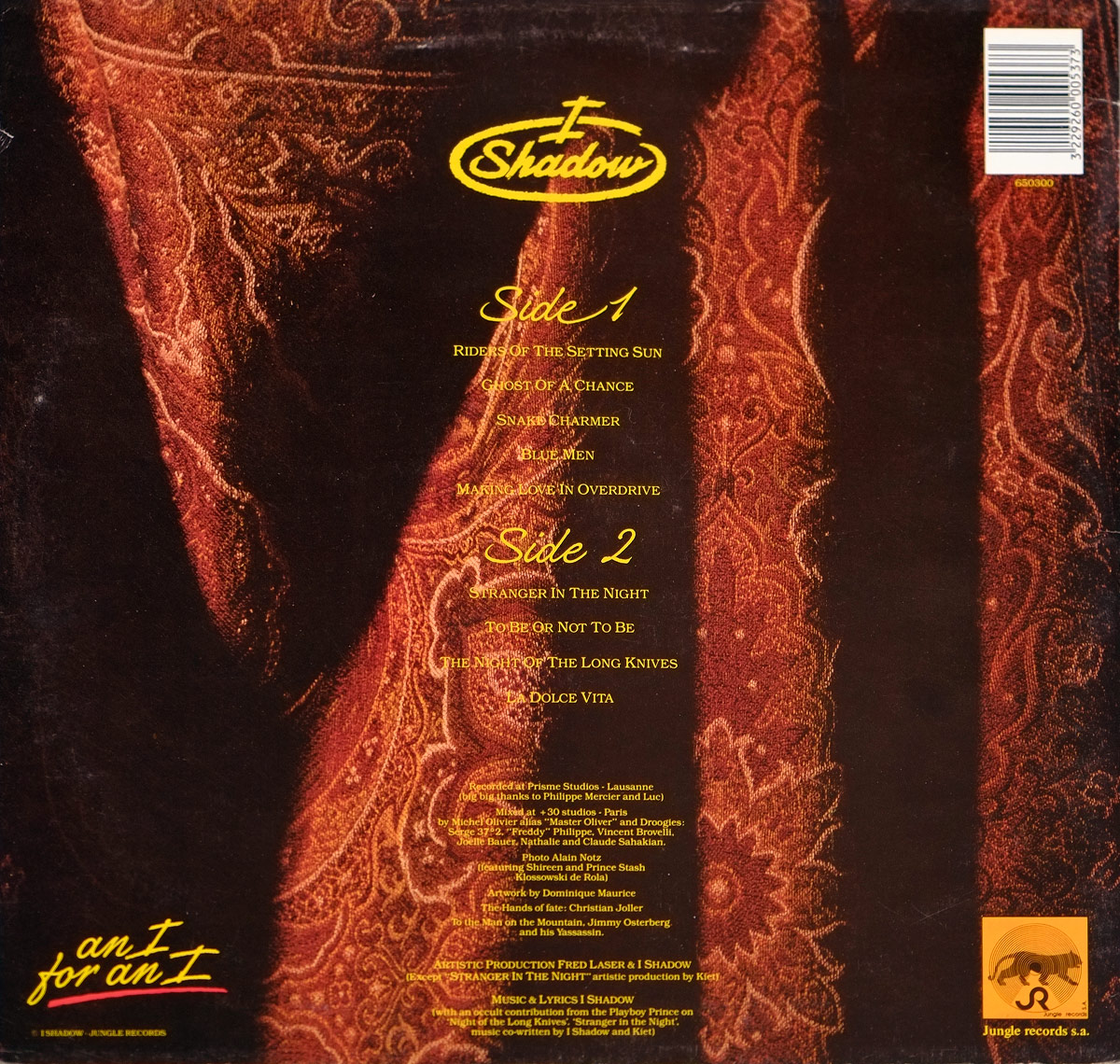 Back cover of I SHADOW – An I For An I showing tracklist in yellow text over dark red fabric, with credits, SUISA reference, and Jungle Records logo.