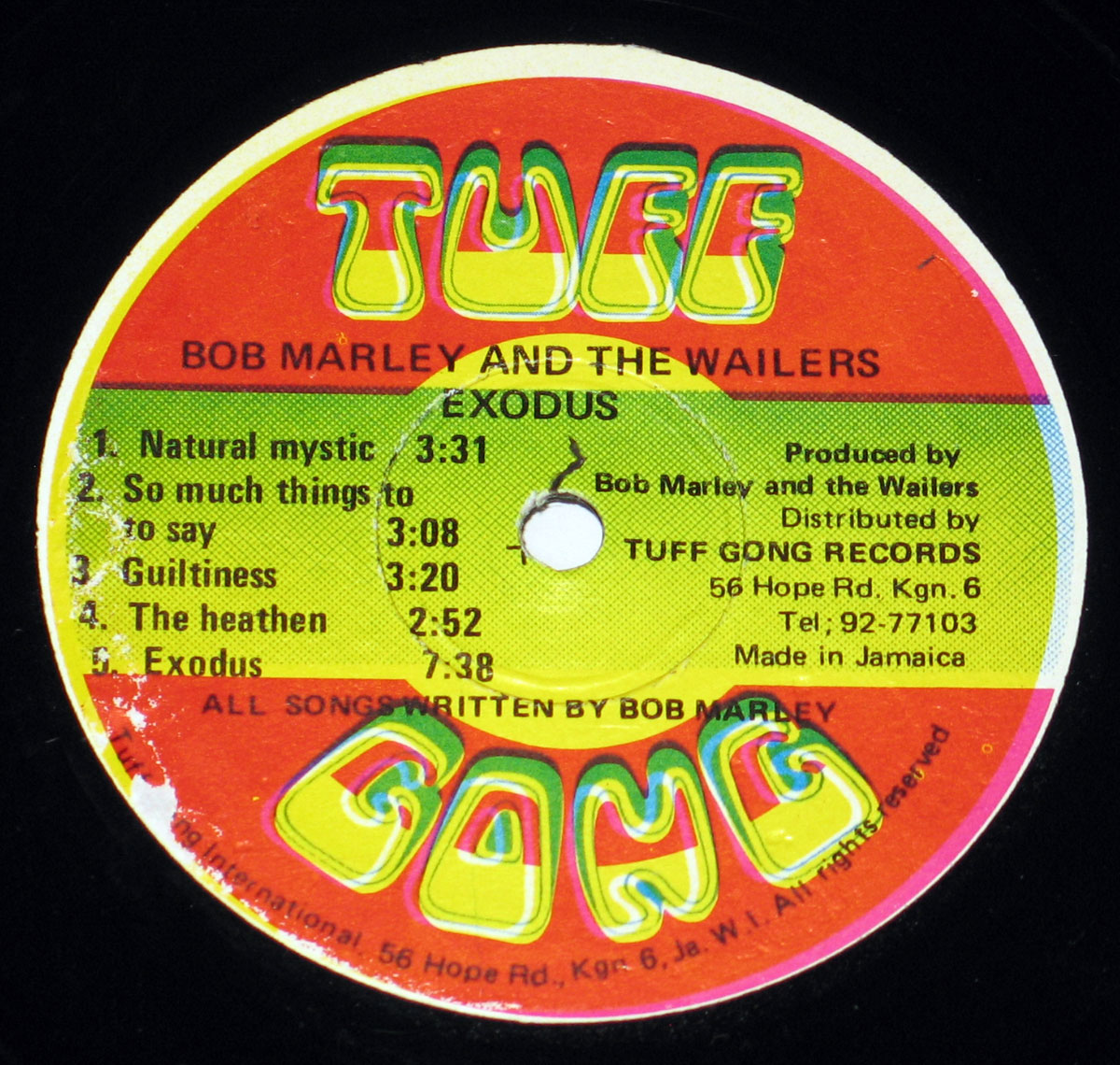 Side One label of Bob Marley & The Wailers' Exodus Tuff Gong Jamaican pressing, showing colorful red-gold-green design with the Tuff Gong logo, tracklist including Natural Mystic and Exodus, and production credits printed around the center hole.