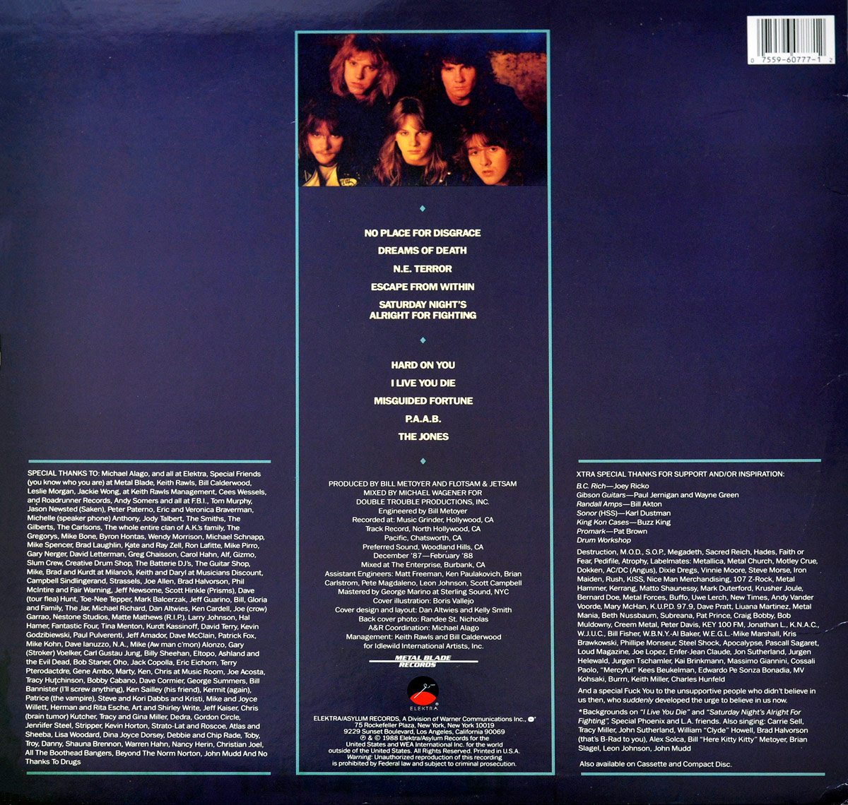 Back cover of Flotsam and Jetsam's 'No Place for Disgrace' album featuring a dark blue background with a centered tracklisting, band credits, and a rectangular band photo at the top. The text is arranged in three columns, including acknowledgments, production credits, and special thanks. The bottom features the Elektra/Asylum Records logo and copyright information.