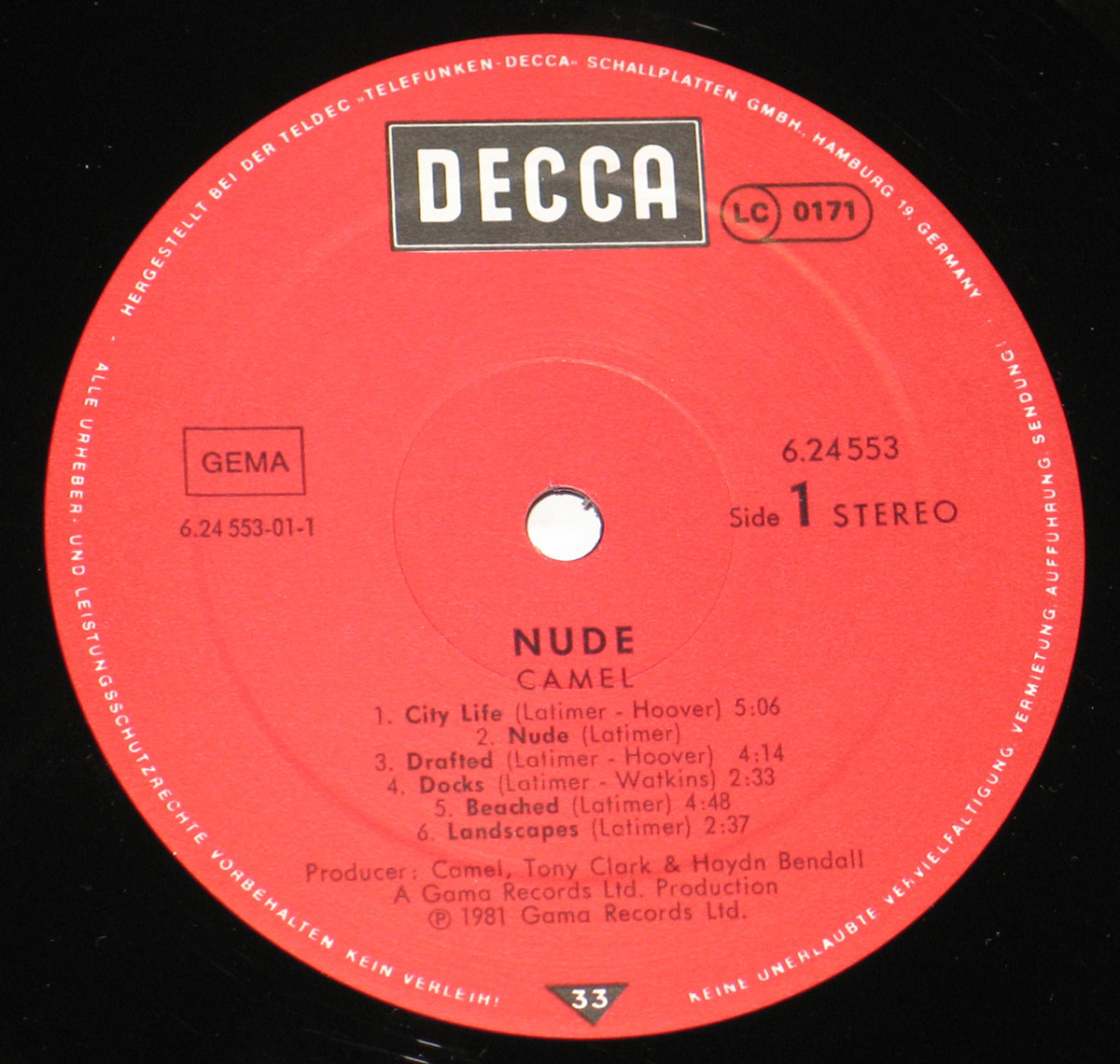 Red Decca record label for Camel's Nude album, featuring the Decca logo at the top, album title and band name centered below, with copyright and catalog details around the edge in German. Produced by Camel, Tony Clark, and Haydn Bendall, released in 1981 by Gama Records Ltd.