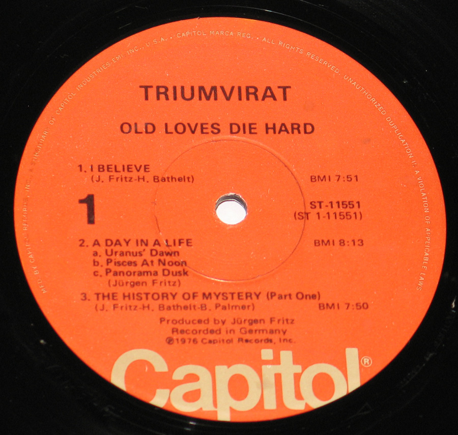 Close up of record's label TRIUMVIRAT - Old Loves Dies Hard Rat Cover 12" Vinyl LP Album
 Side One