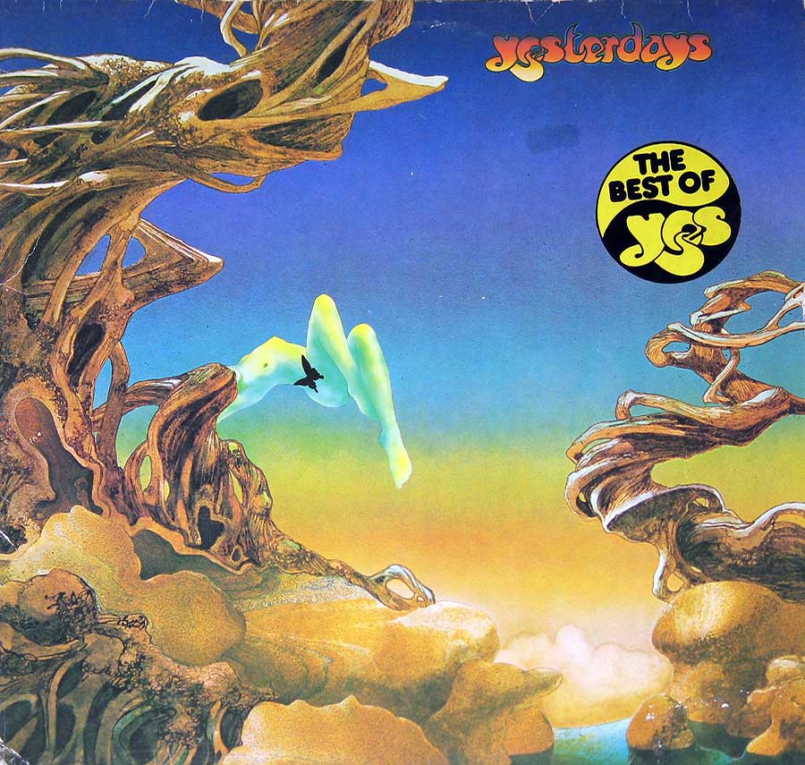 The cover of Yes's Yesterdays compilation album, illustrated by Roger Dean, depicts a surreal landscape with twisted, tree-like formations framing a serene sky transitioning from blue to orange. A distant, ethereal creature appears to soar in the background, evoking a dreamlike atmosphere. The organic shapes and vibrant colors complement the album’s retrospective theme, reflecting the band’s unique and imaginative style.