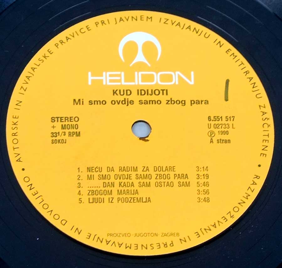 Close up of record's label KUD IDIJOTI - Mi Smo Ovdje Samo Zbog Para Jugoslavia 12" LP Vinyl Album Side One