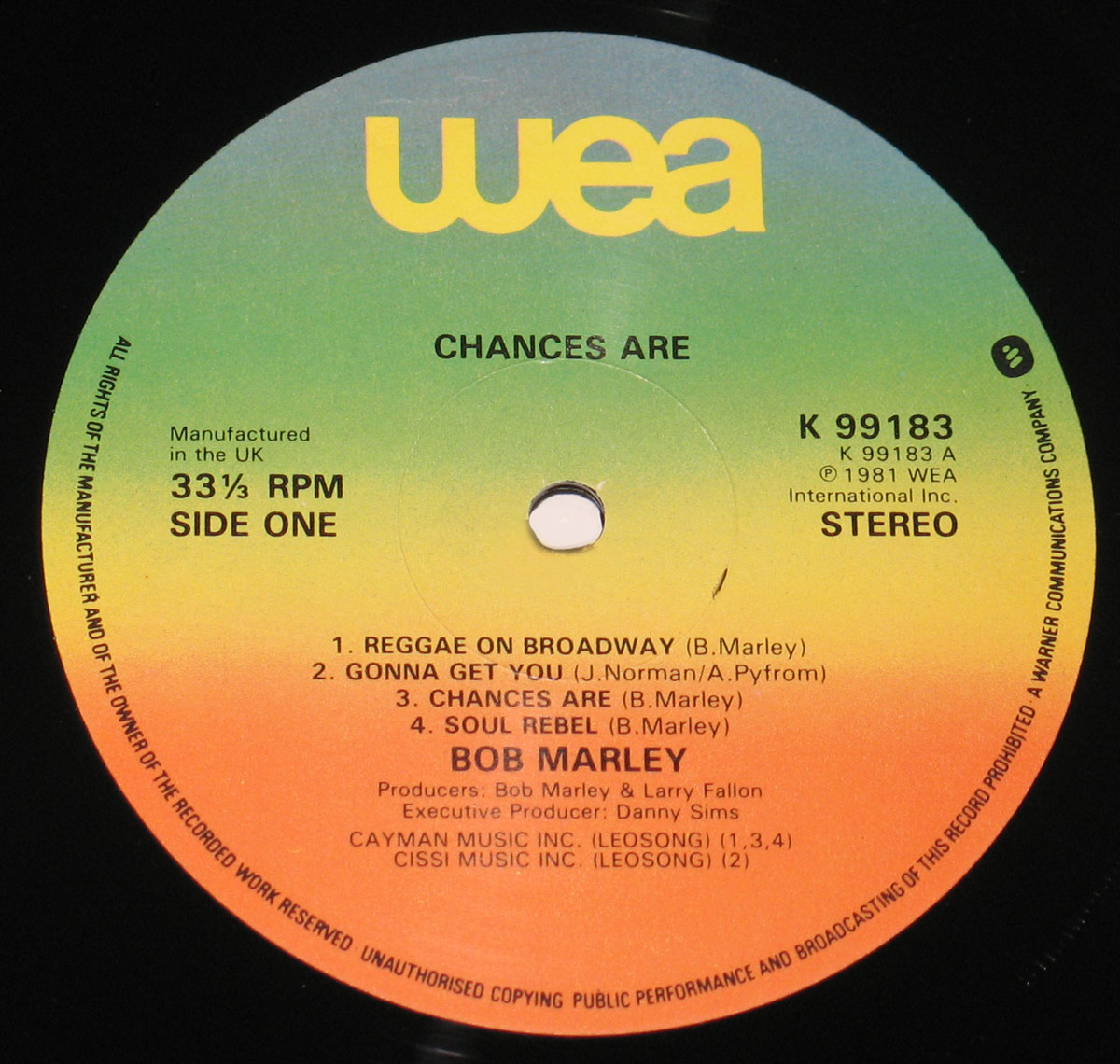 Close-up of Side One label of Bob Marley’s 'Chances Are' LP, showing track listing, producer credits, and colorful WEA gradient design. UK pressing with catalog number K 99183.
