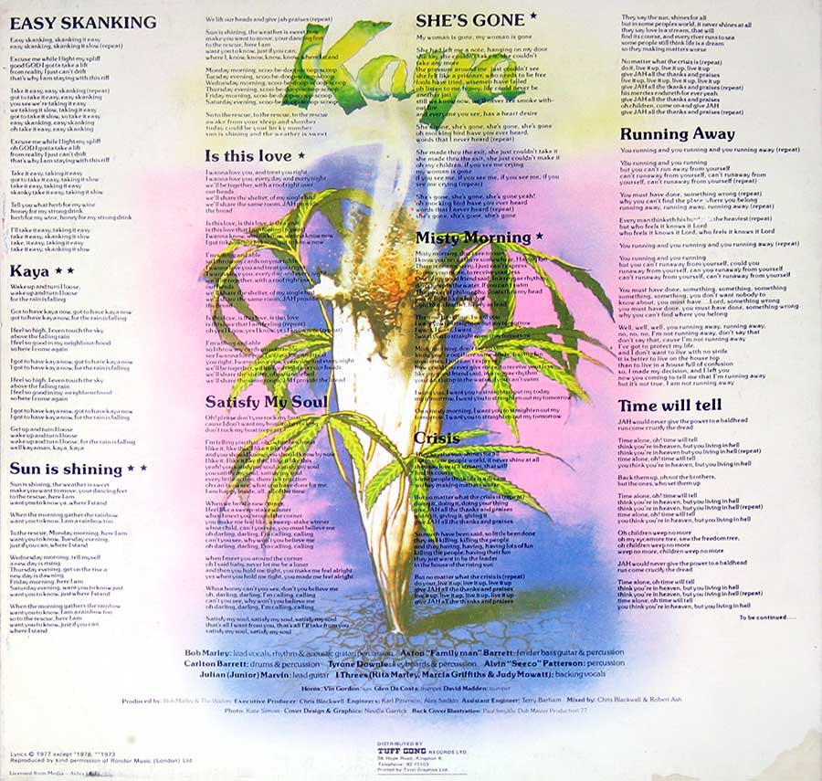 Back cover of Bob Marley & The Wailers' Kaya album, displaying the song lyrics arranged around an illustration of a cannabis plant with green leaves and a smoky aura. The background features a gradient of soft pink, purple, blue, and yellow, giving a dreamy effect. The title 'Kaya' appears at the top center, and production credits are listed at the bottom.