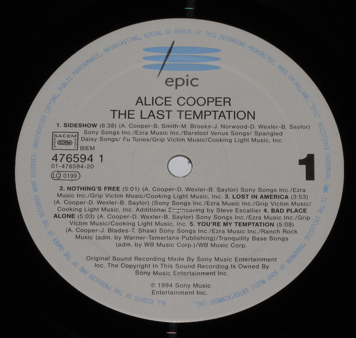 Side 1 label of Alice Cooper's The Last Temptation vinyl, grey with blue Epic logo, song titles, credits, SACEM/SDRM/BIEM info and catalog number EPIC 476594 1.
