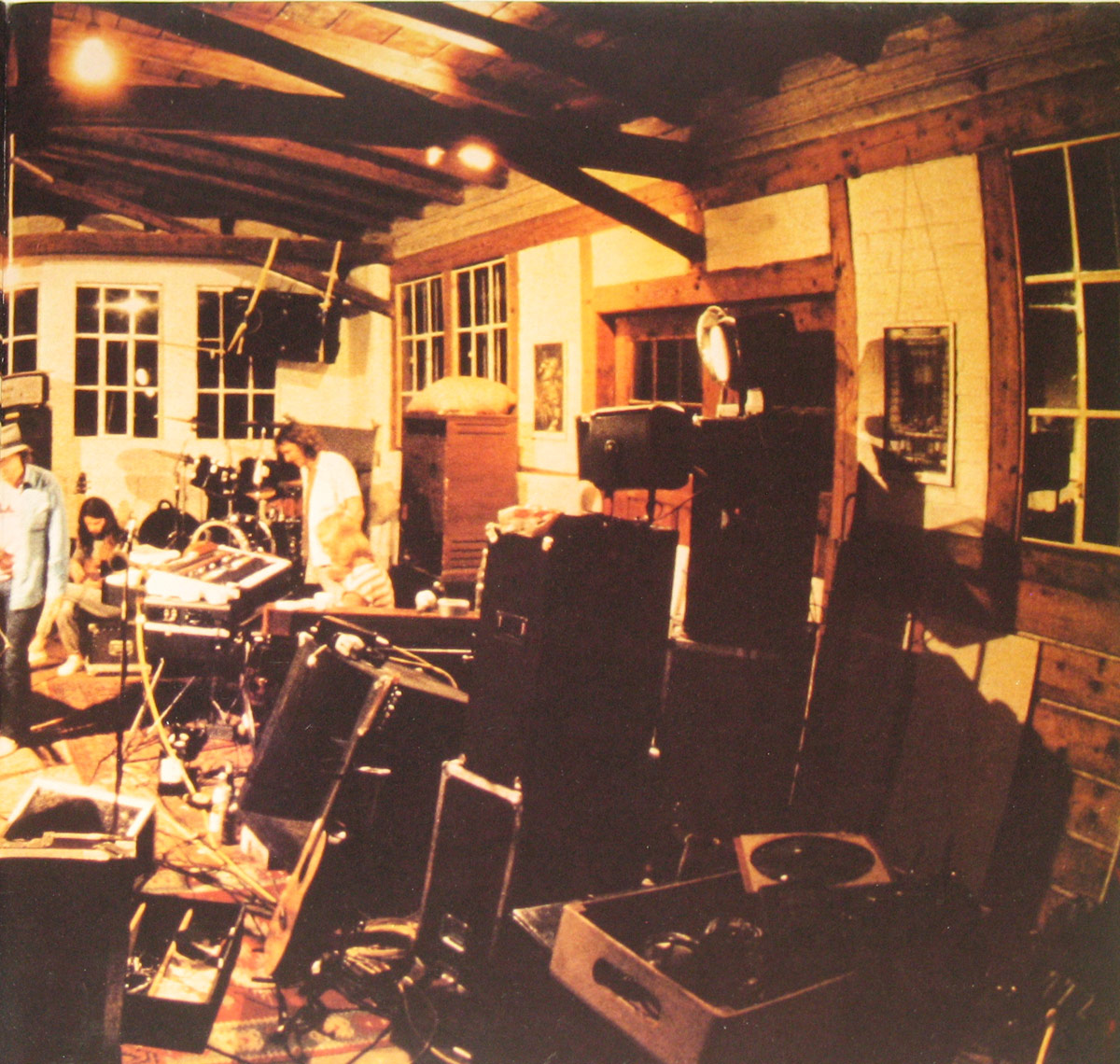 Interior photo from BAP's 'Vun Drinne Noh Drusse' album showing a warmly lit rehearsal space with instruments, cables, and band members preparing for a session.