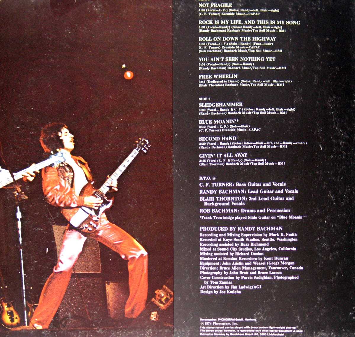 Right inner gatefold of BTO Not Fragile LP showing guitarist in red leather outfit and printed credits, tracklist, and production notes on black background
